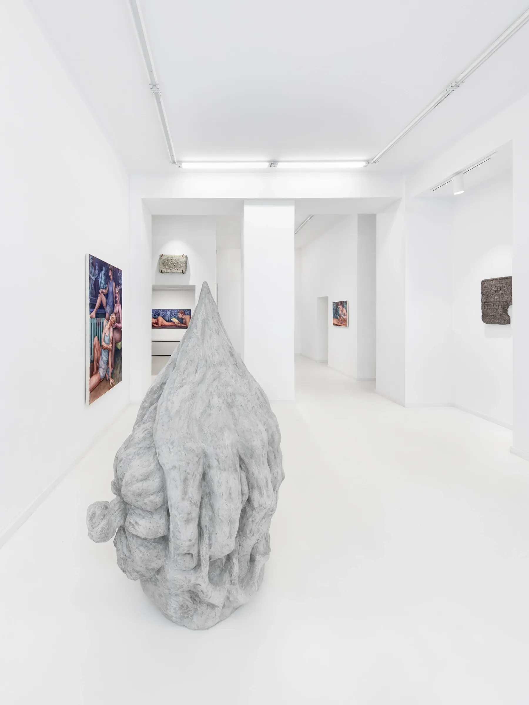  Maciej Nowacki and Miłosz Tomkowicz, Blood Concrete Sun, HOS Gallery, Warsaw, 2026, wide view through several rooms with a concrete sculpture in the foreground