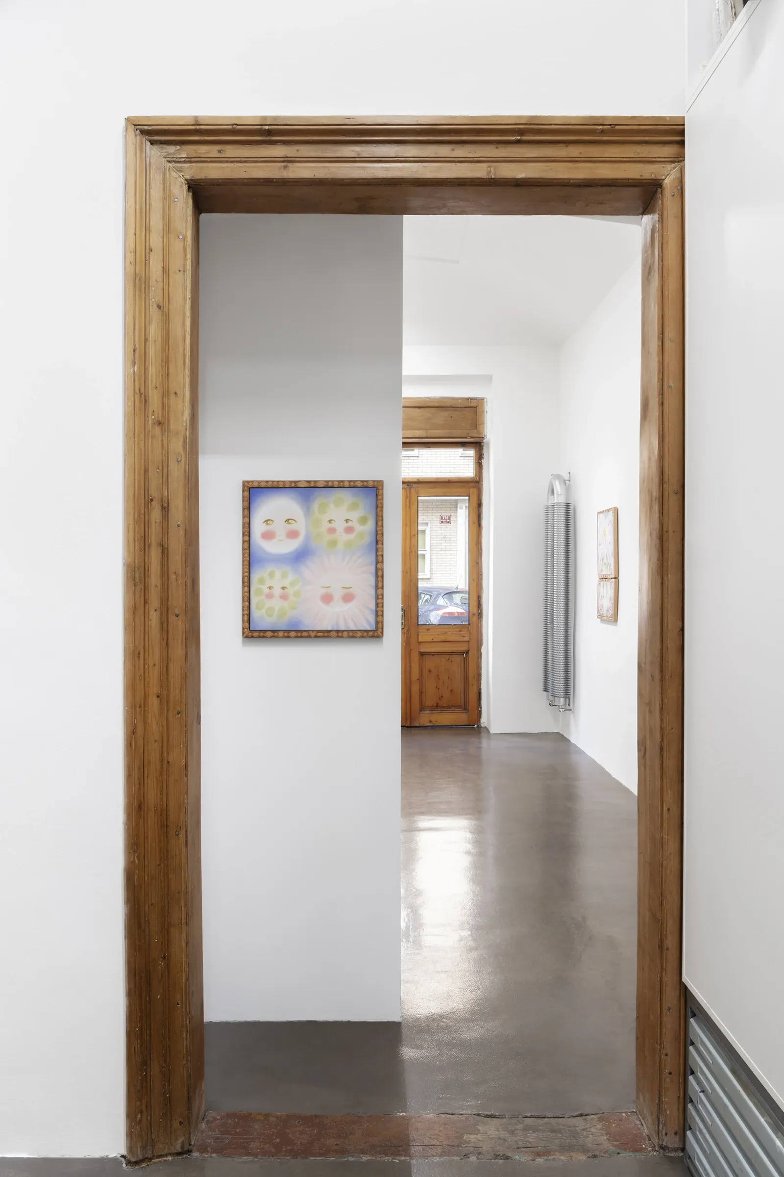 Olga Krykun, Stardust for Tomorrow, Clauda, Prague, 2026, corridor toward the entrance door with a radiator and painting
