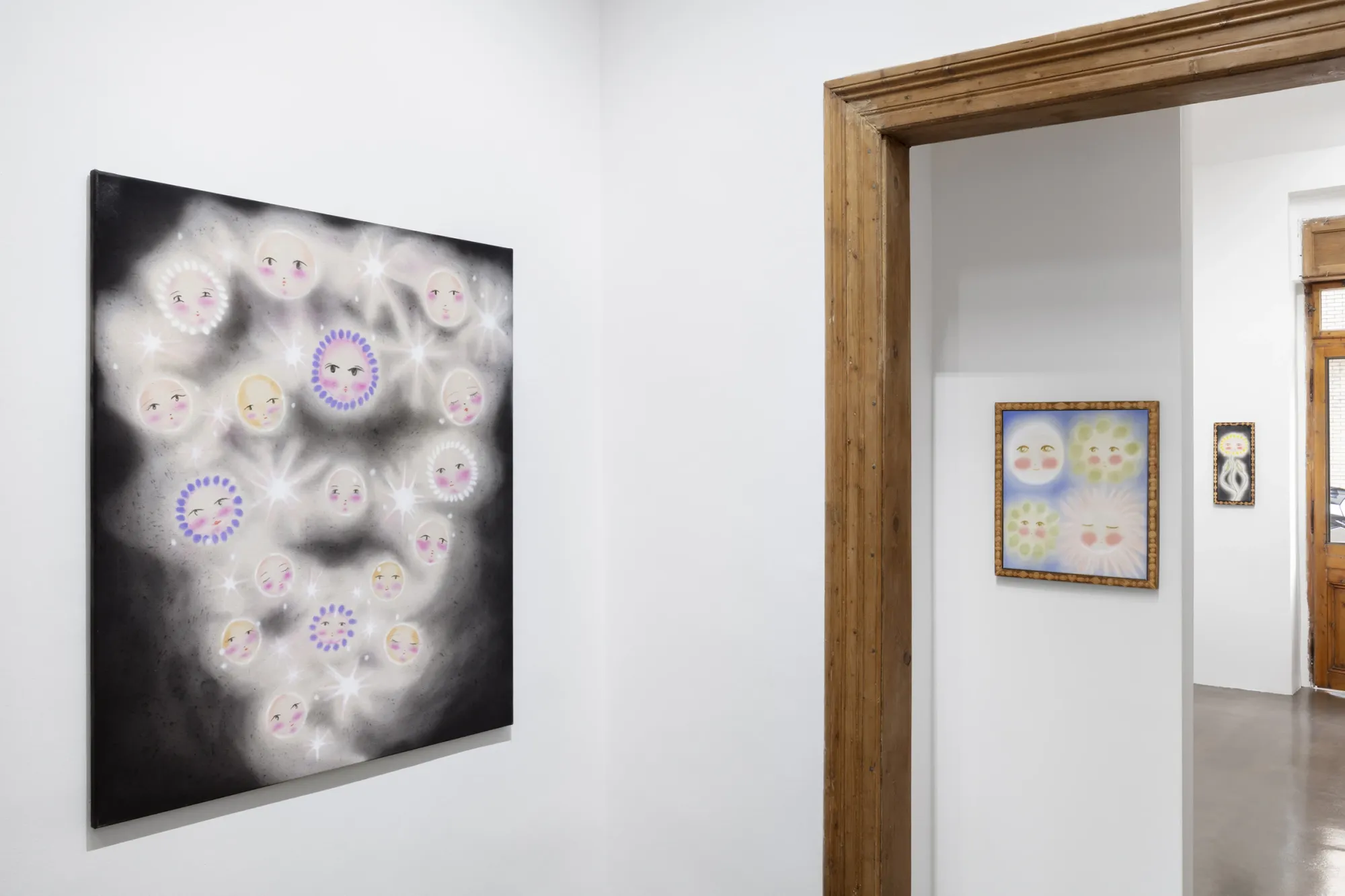 Olga Krykun, Stardust for Tomorrow, Clauda, Prague, 2026, two rooms with a star-face canvas and a small four-face painting