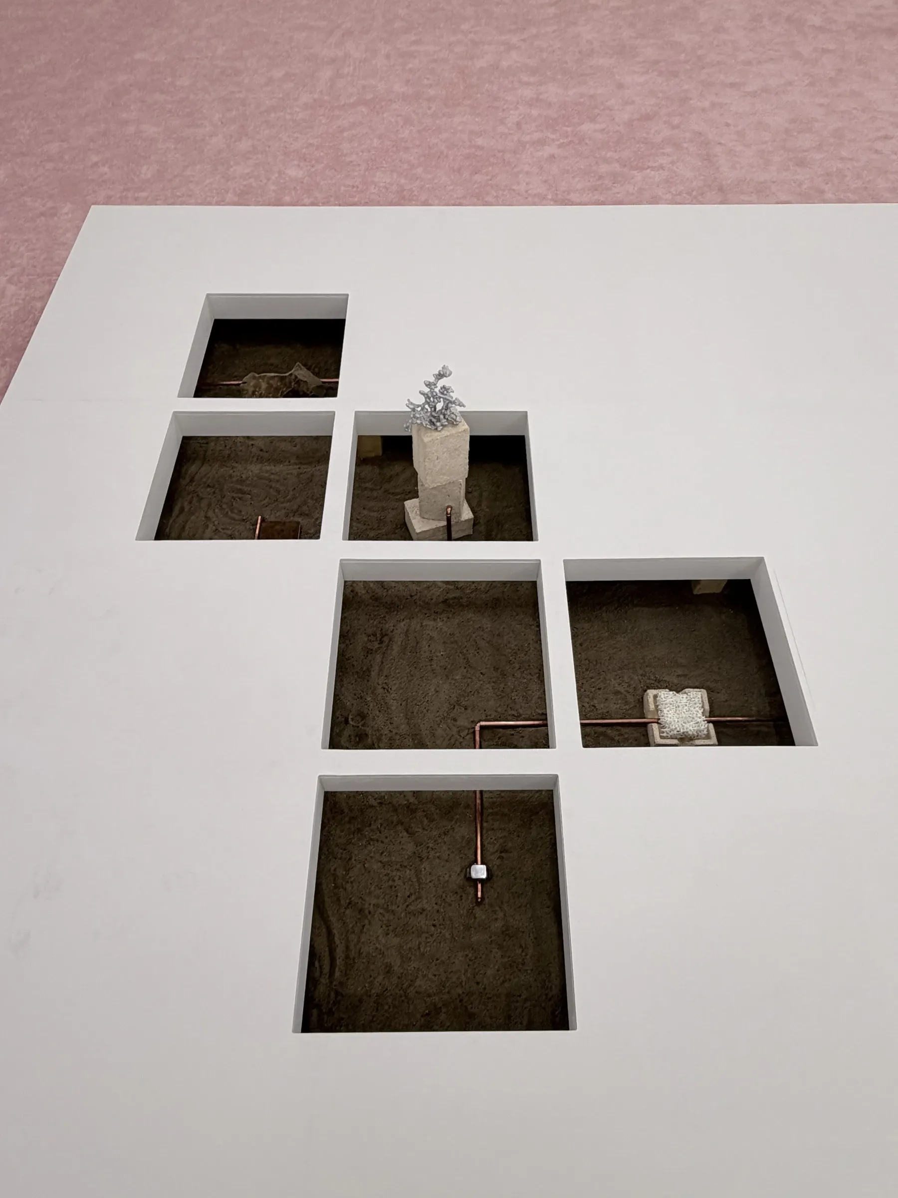 Patrick Bérubé, Deserted network, (Ce)pendant [(Now)ever], Musée d'art de Joliette, 2026, overhead view of sunken floor squares