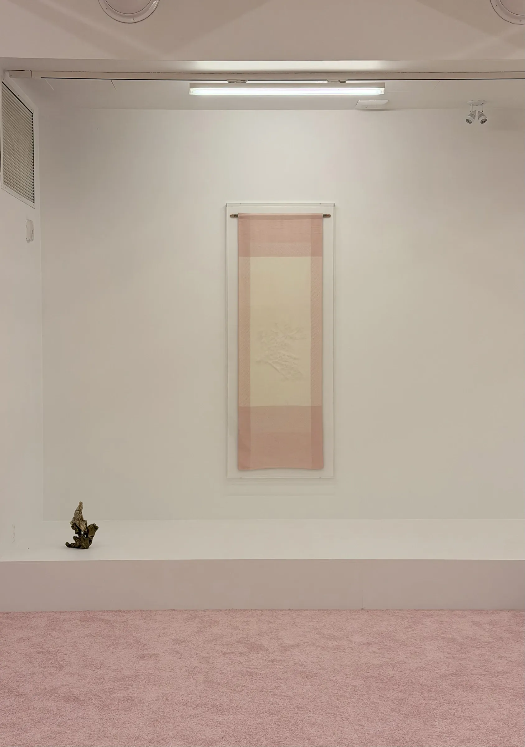 Patrick Bérubé, Shadow, (Ce)pendant [(Now)ever], Musée d'art de Joliette, 2026, hanging textile scroll beside a small bronze form
