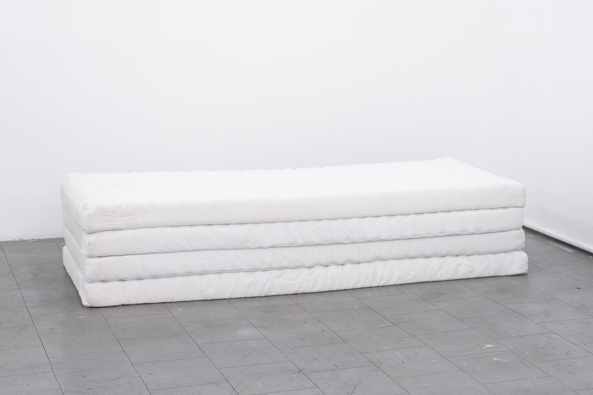Ville Laurinkoski, Object of Devotion, Skånes konstförening, Malmö, 2026, detail of stacked white mattresses