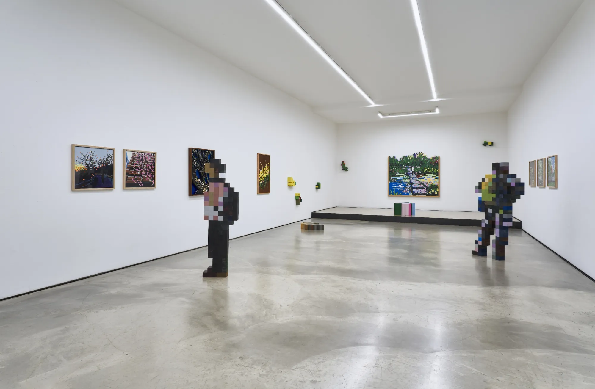 Artist Profile Feature: Jaebum Joo, studio practice and artwork at Hakgojae Gallery, Seoul, 2026. Wide gallery view, framed panels and a standing wood-block figure sculpture.