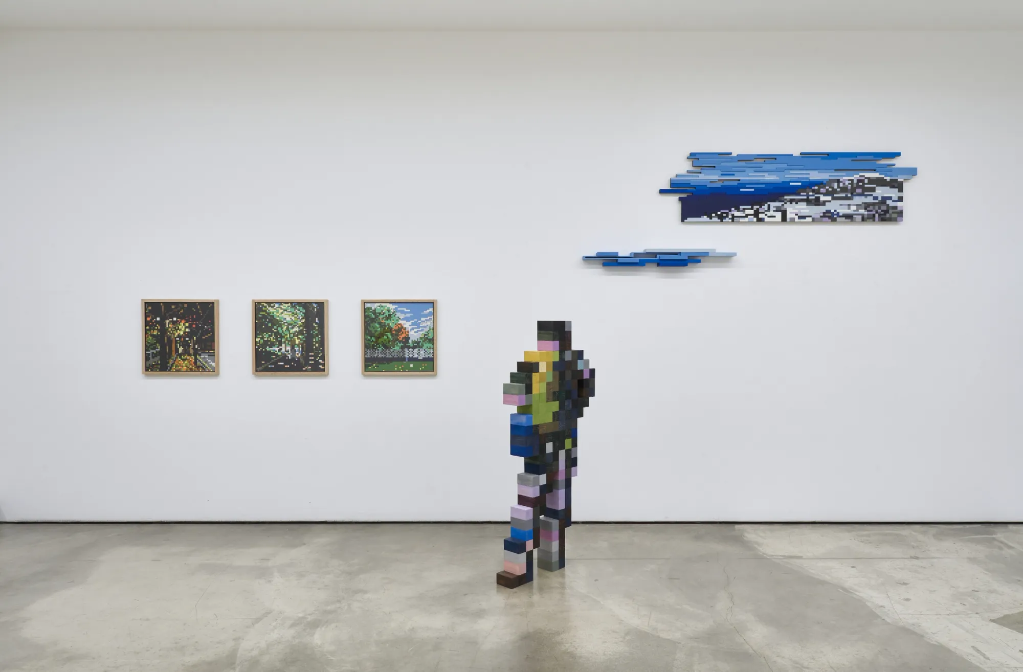 Artist Profile Feature: Jaebum Joo, studio practice and artwork at Hakgojae Gallery, Seoul, 2026. Wall with three small framed landscapes and blue wave-form wall reliefs.