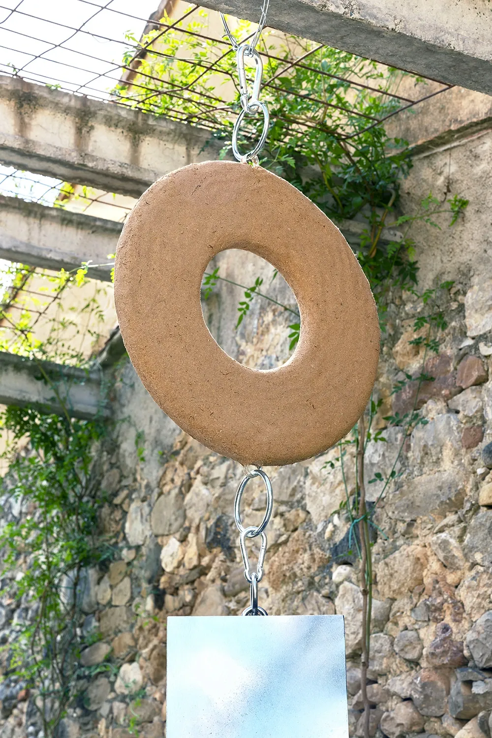 Exhibition review of Leah Dixon: Tartan Tartana at Spiritvessel, Espinavessa, 2026. Close-up of a large sawdust and resin disc with sky visible through its center.