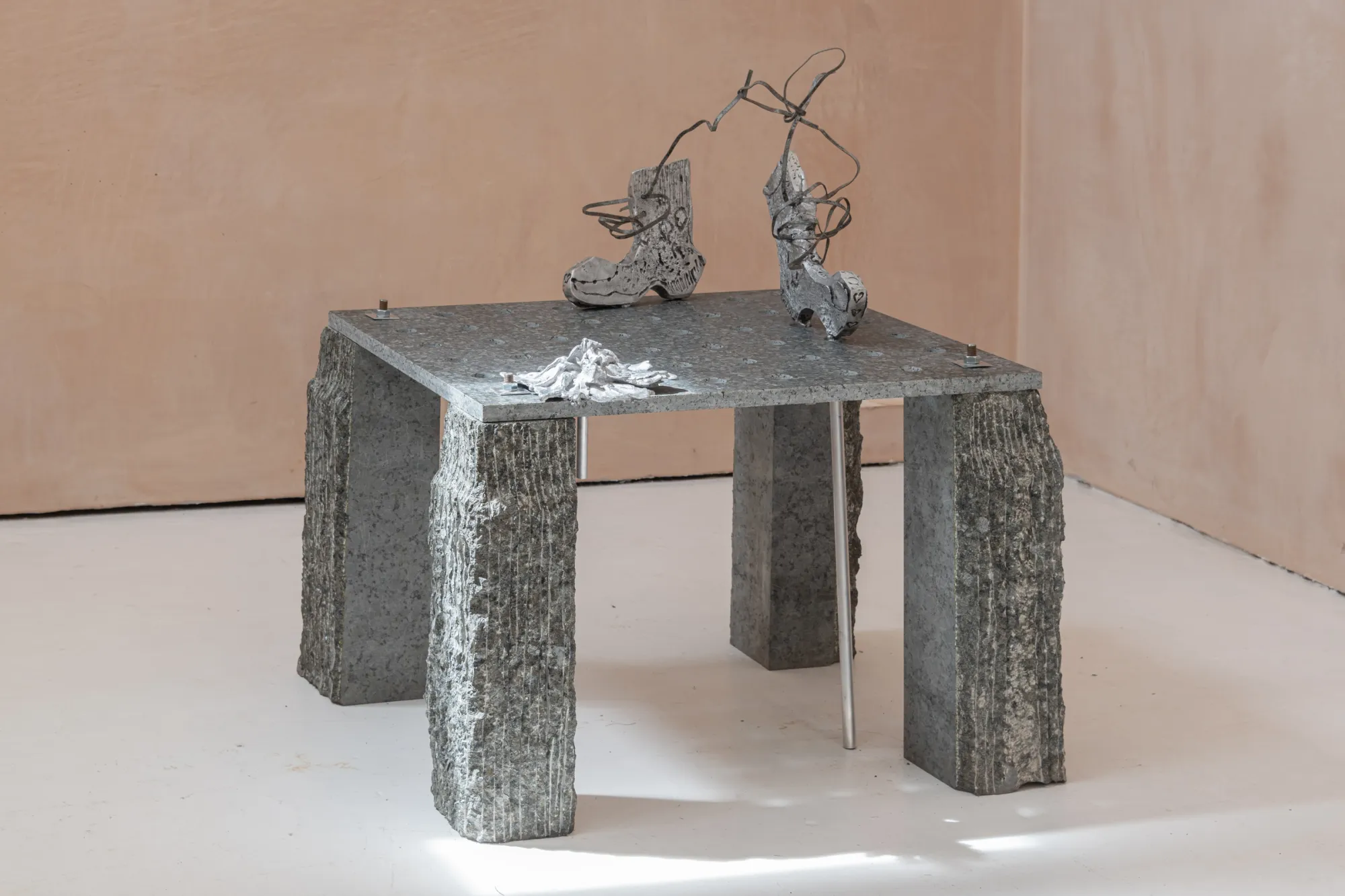 Exhibition review of Maija Fox: As the sap rises at OUTPOST, Norwich, 2026. Two standing cast figures with wire antennae on a granite table.