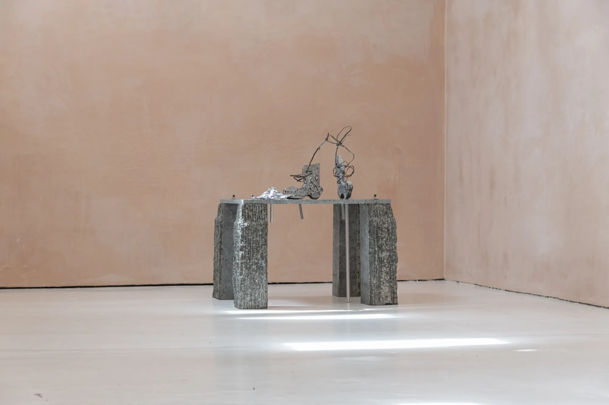 catapult contemporary art platform Exhibition review of Maija Fox: As the sap rises at OUTPOST, Norwich, 2026. Two small cast figures on a narrow twin-pillar granite table.