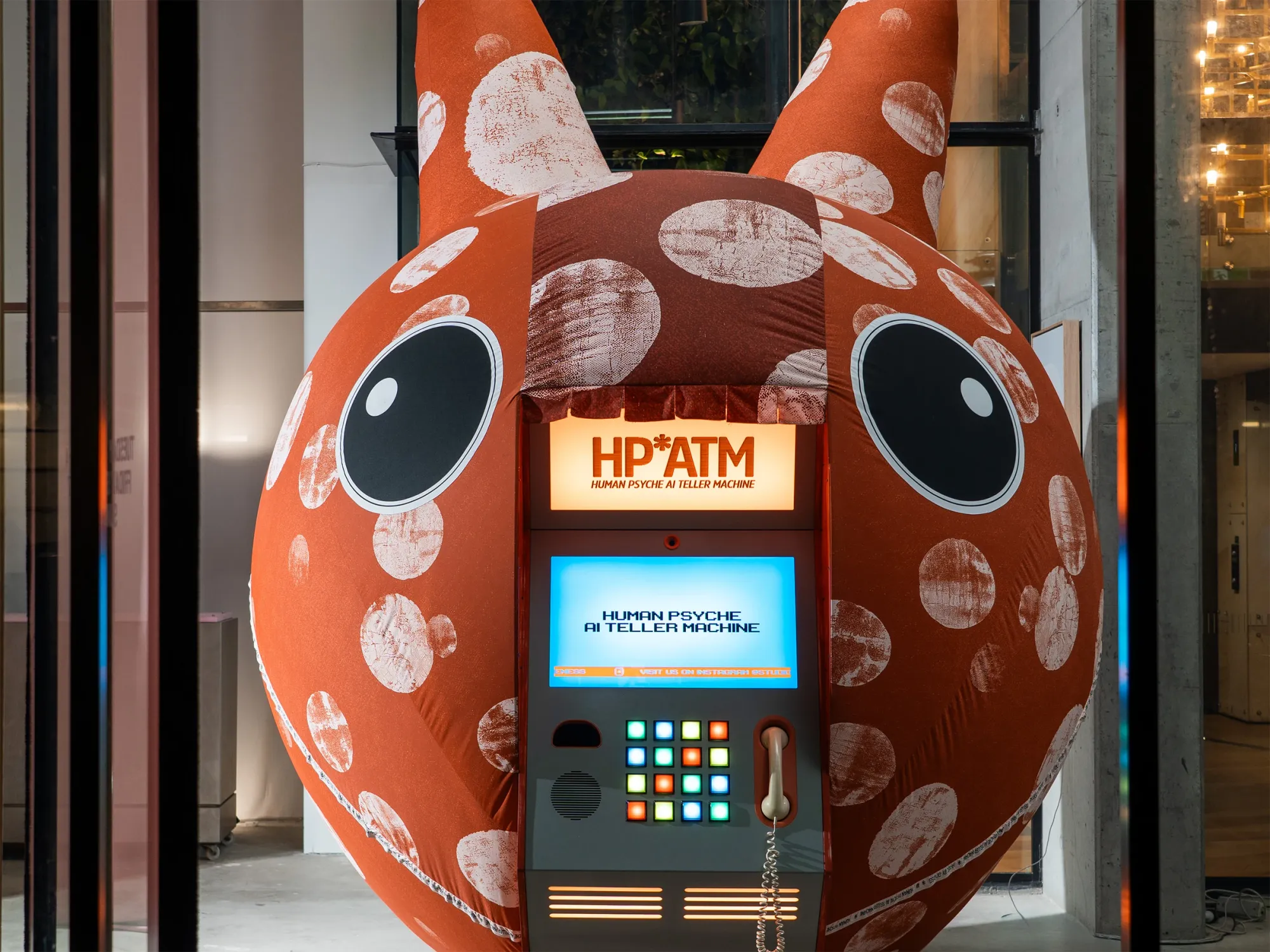Exhibition review of Nimrod Weis: HPATM at FUTUREJUICE, Adelaide, 2026. Close frontal view of the orange polka-dot sculpture and its console.