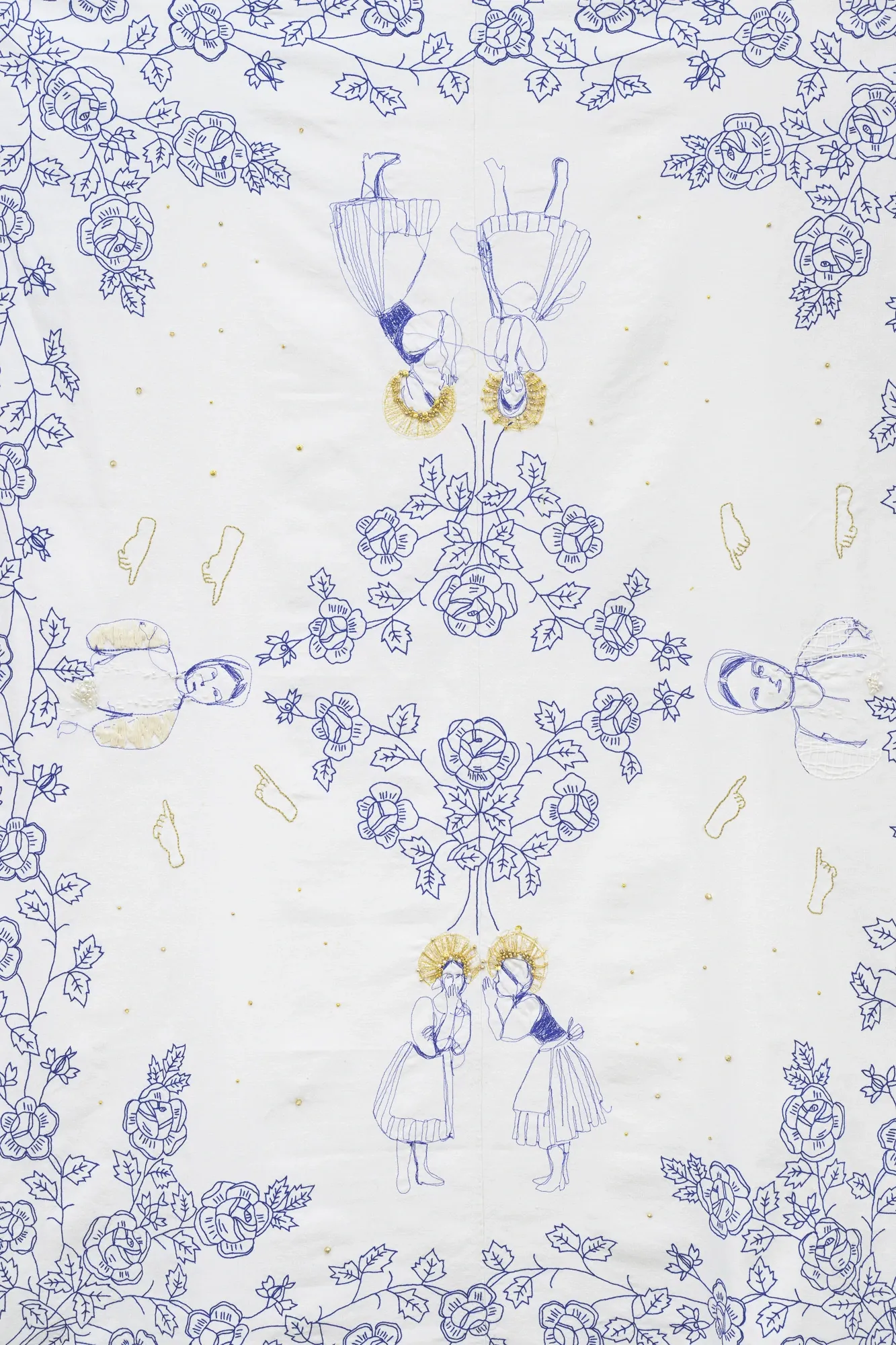 Exhibition review of Soft Power: close-up detail of blue floral embroidery with symmetrical folk figures on white textile.