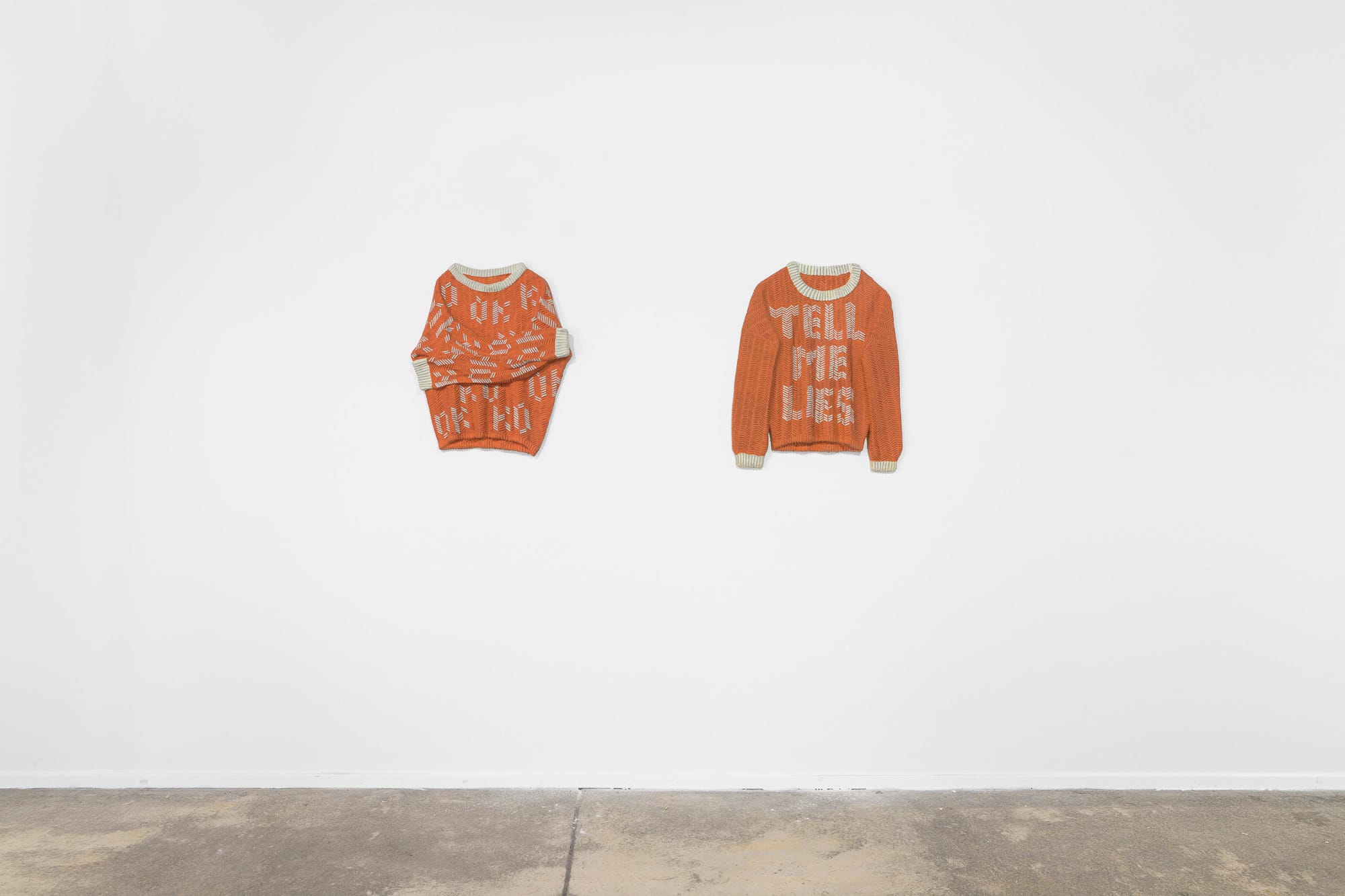 DANA BARTONÍČKOVÁ , artwork for Catapult contemporary art platform Exhibition review of Soft Power: two concrete relief sculptures shaped as knitted sweaters mounted on white wall.