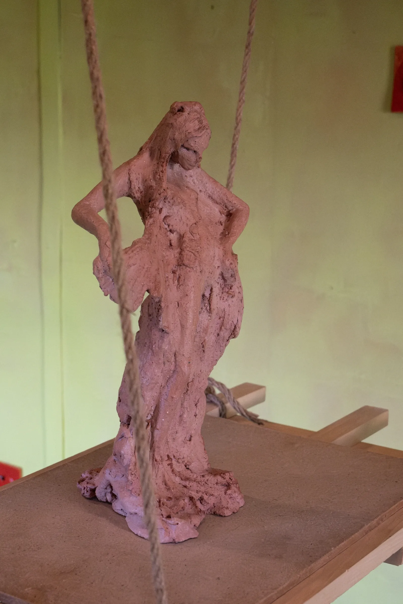 Exhibition review of Tsvetomira Borisova: A Hot Day at lo3eto, Vetren dol, 2026. Close-up of the rough red clay surface of the female figure's torso and head.