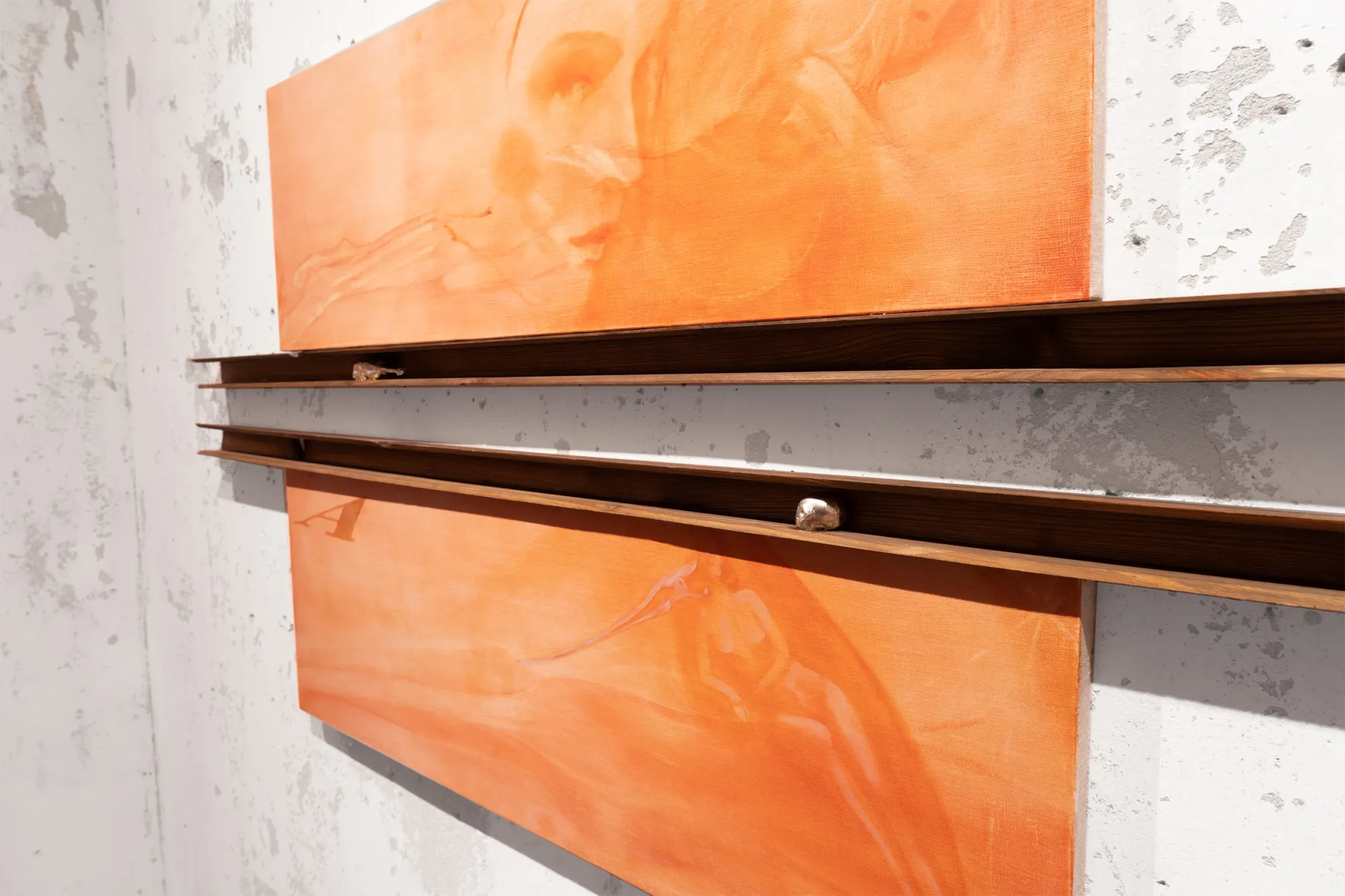 Exhibition review of Amelia Woroszyl: Silly! Devil! at Crum Heaven, Stockholm, 2026. Close-up of a small skull charm set into a dark wood rail against a white wall.