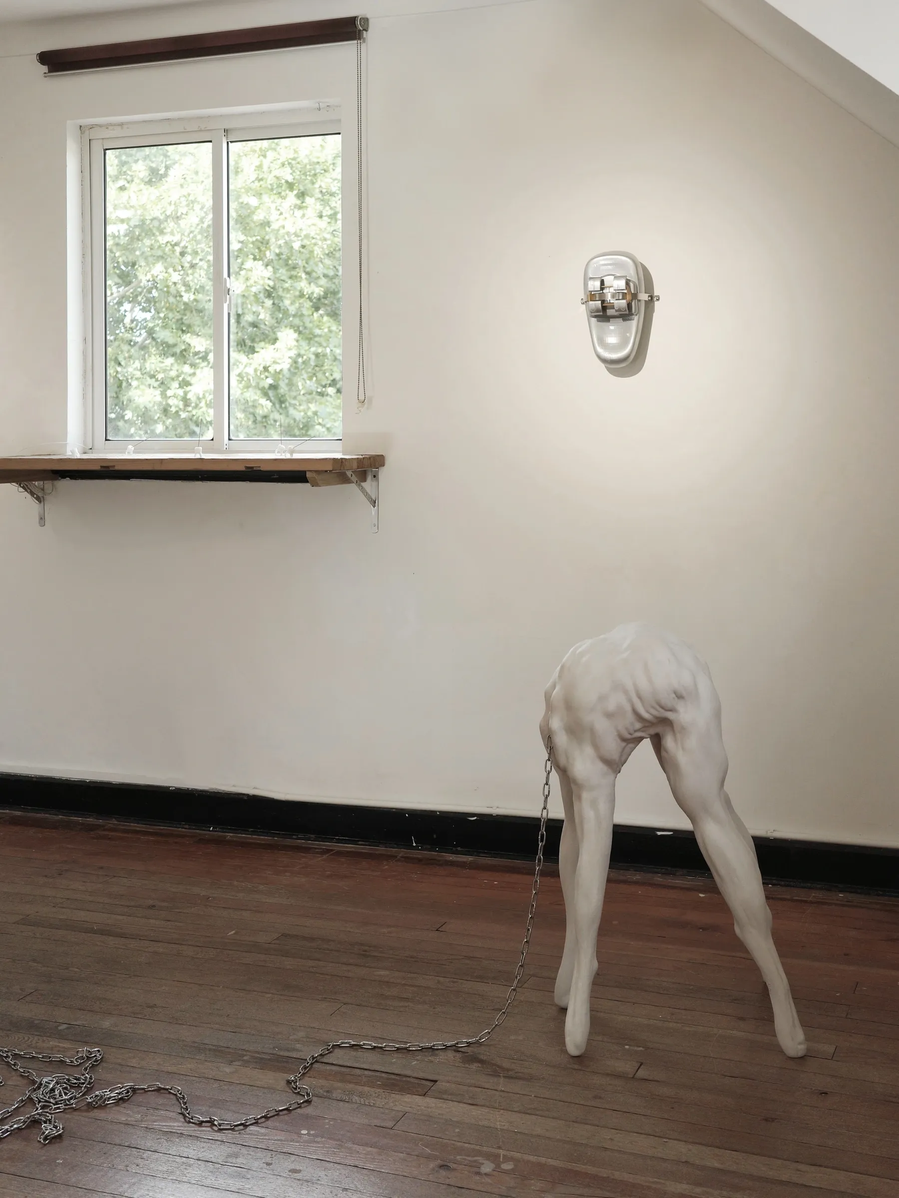Exhibition review of Eva Chenyao He: Procrustean at COLLECTA, Shanghai, 2026. A large pale oval resin form clamped flush to a white wall.