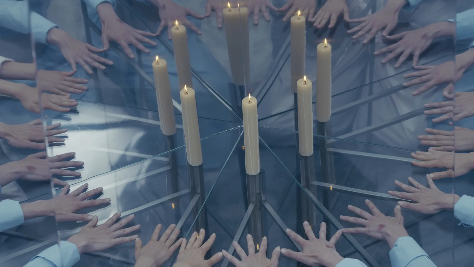 Exhibition review of I Think My Body No Longer Belongs to Me at roam projects e. V., Berlin, 2026. Ring of hands on glass around lit white candles