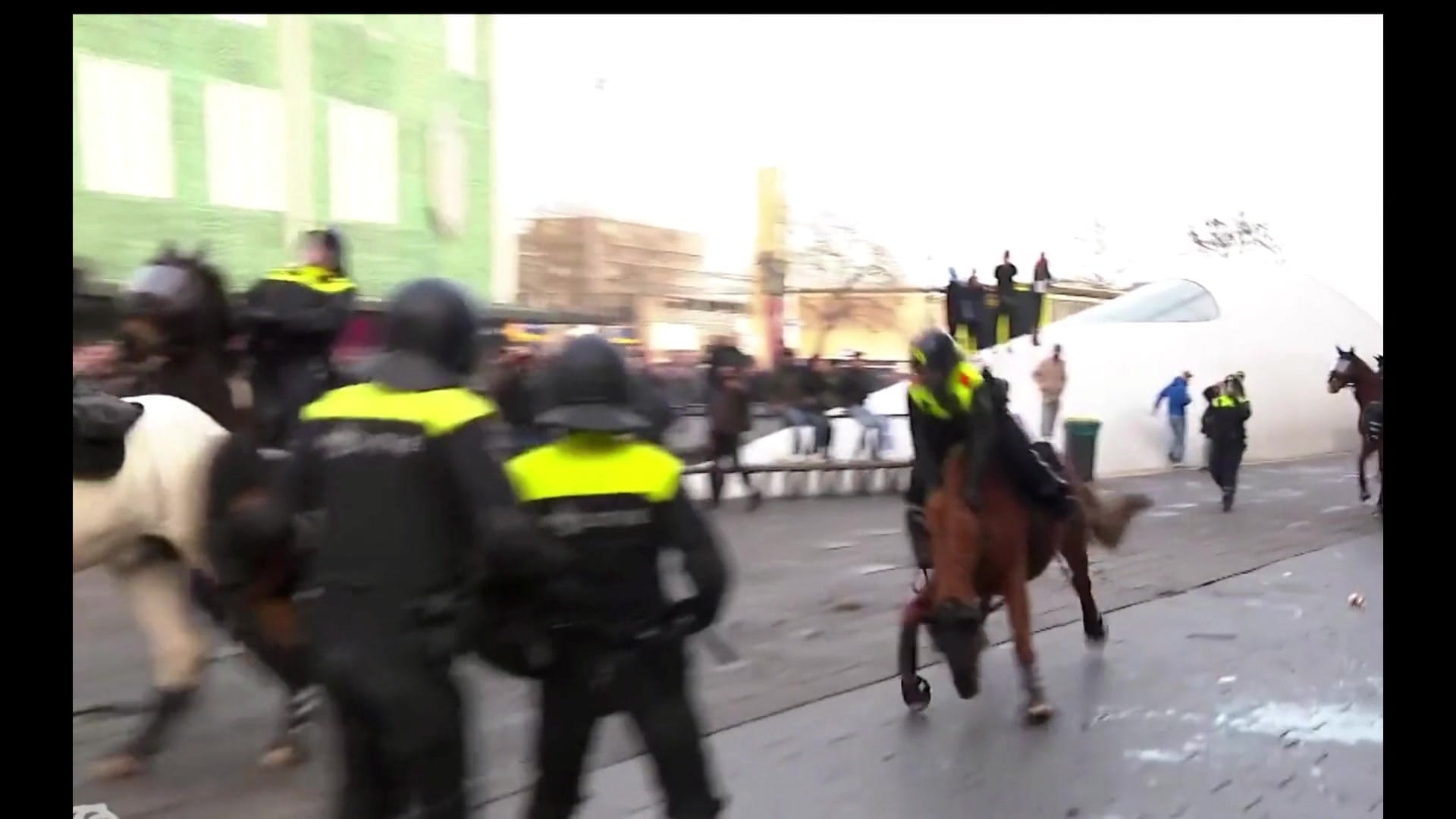 Exhibition review of Josefin Arnell: A Charm of Powerful Trouble at ACUD Galerie, Berlin, 2026. Video still of mounted riot police and horses in a blurred outdoor scene