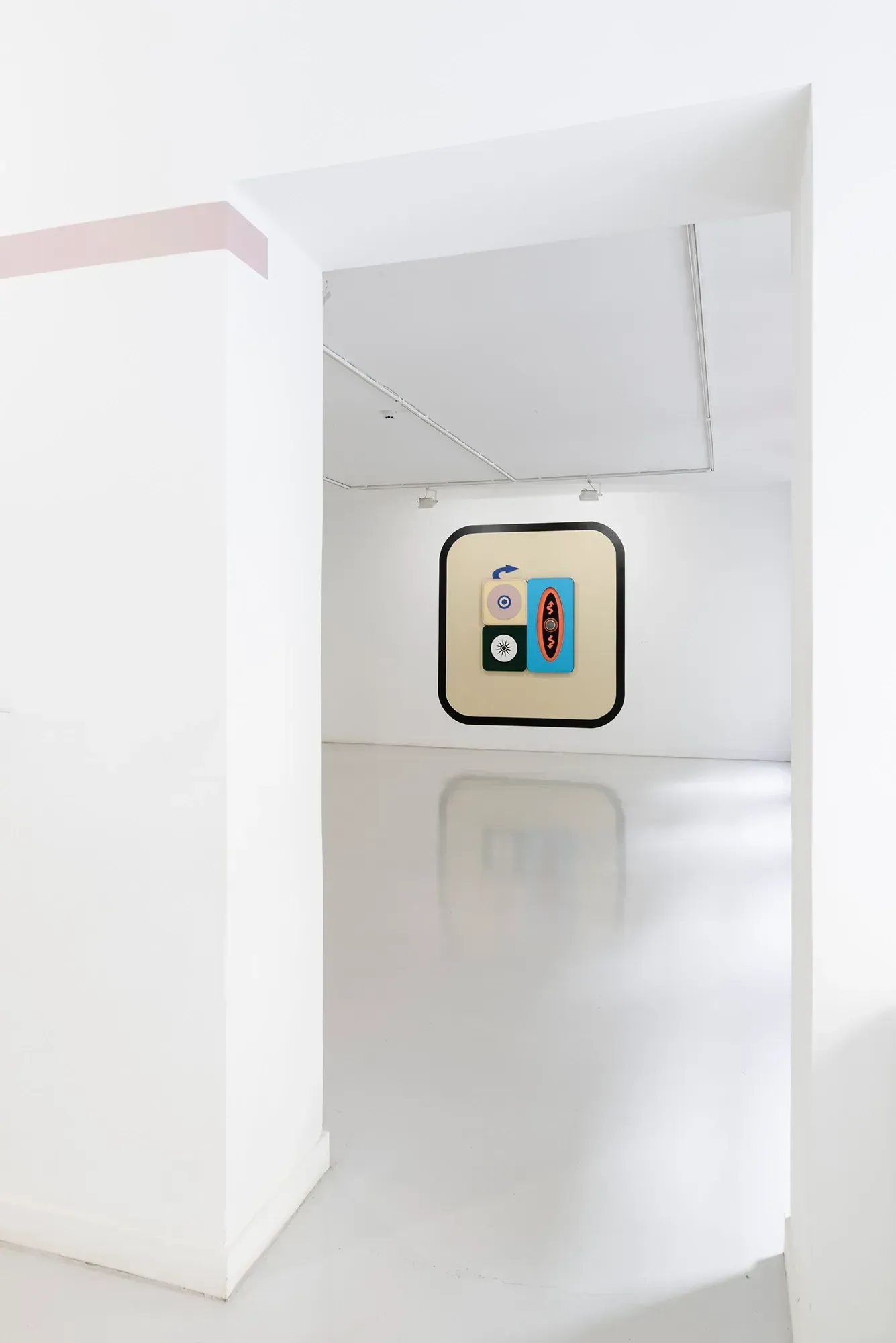 Exhibition review of Kaija Hinkula: You Are Here at Ama Gallery, Helsinki, 2026. A view down an empty white hallway toward a distant framed relief.