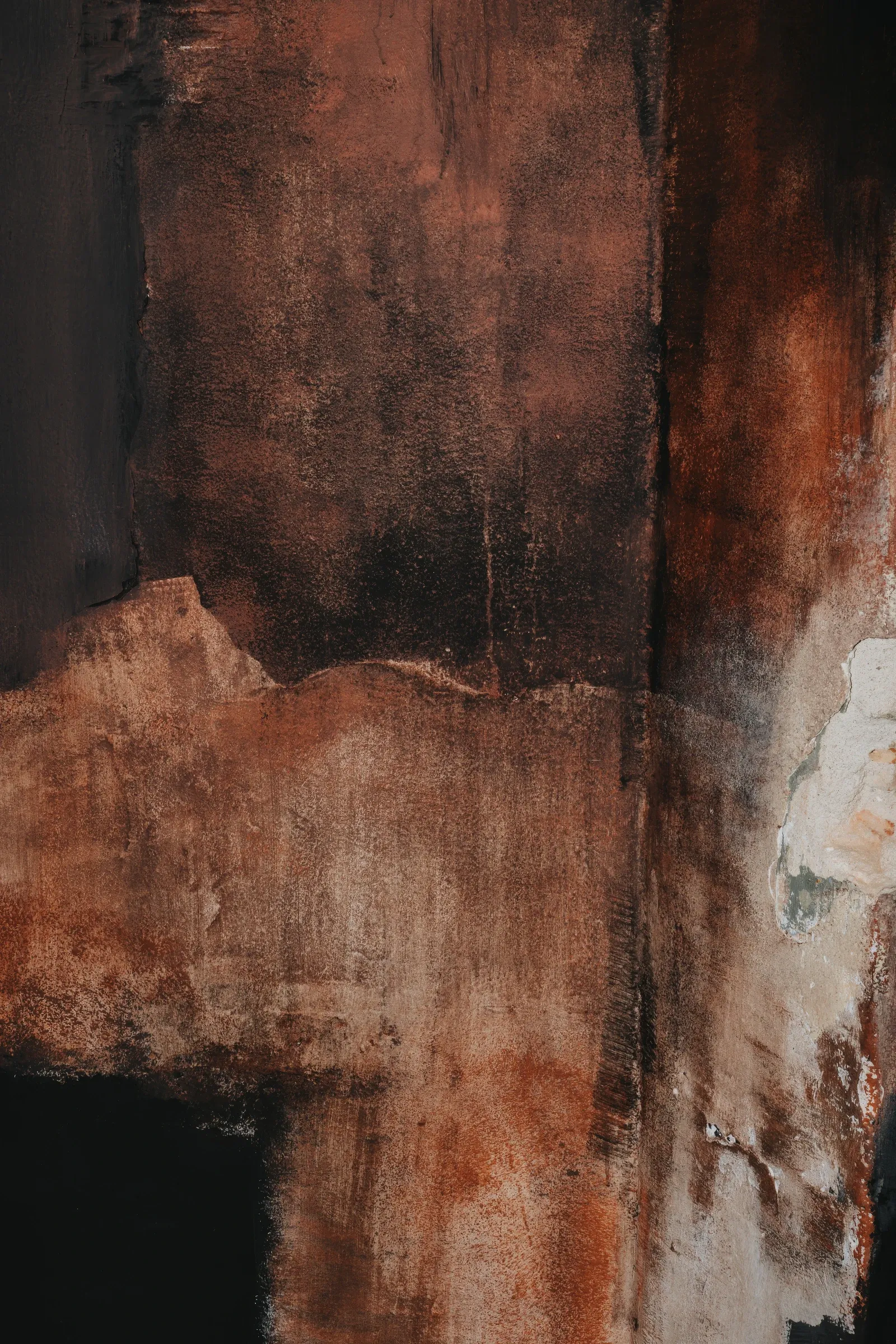 Exhibition review of Paulina Semkowicz: Residency: The Wall at Galeria S35, Łódź, 2026. Close-up of rust-red pigment over dark brown and black with a patch of cracked white plaster.