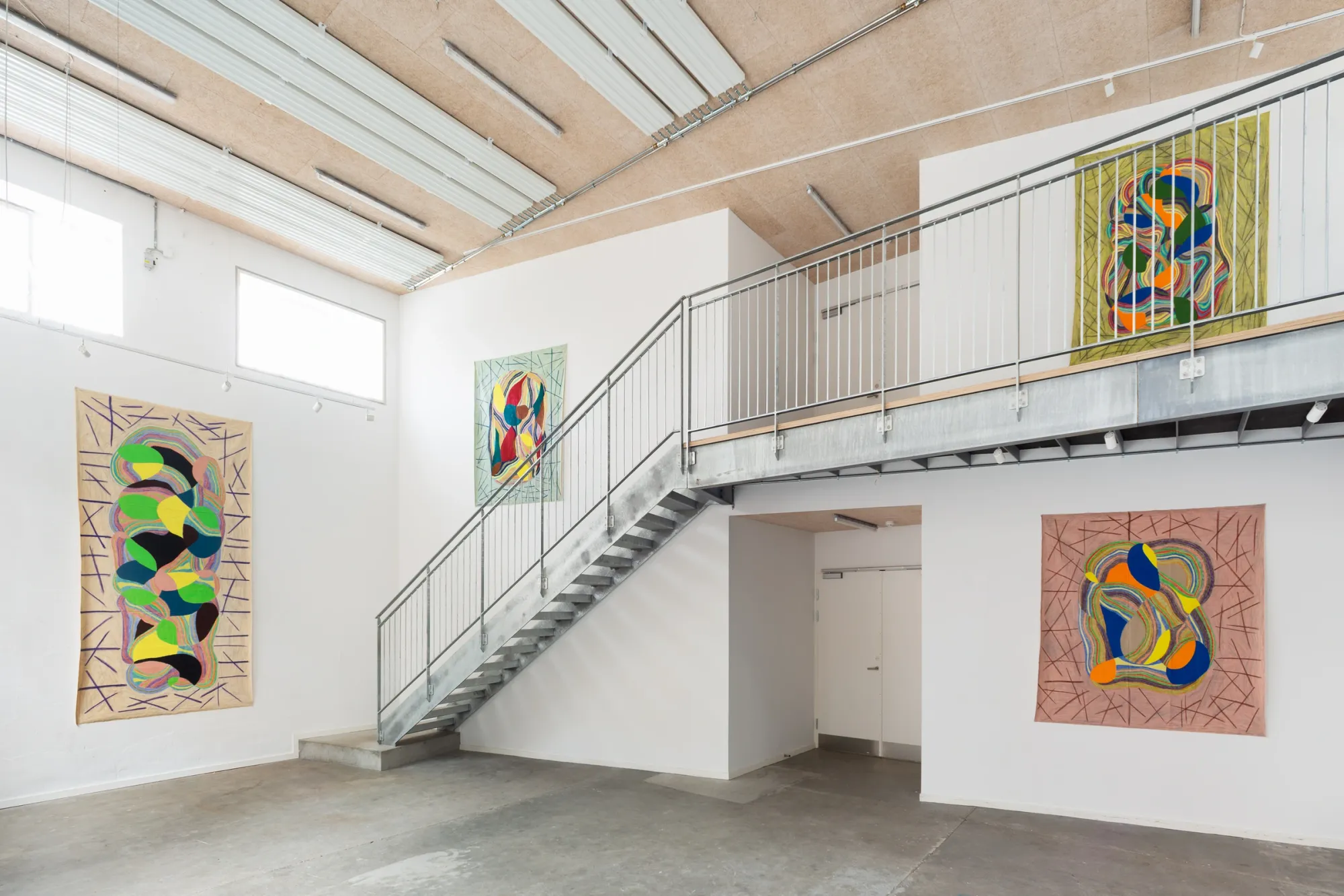 Artist Profile Feature: Sophie-Luise Passow, artwork at Aarhus Billedkunstcenter, 2026. Four linen works in a tall white hall with steel stairs.