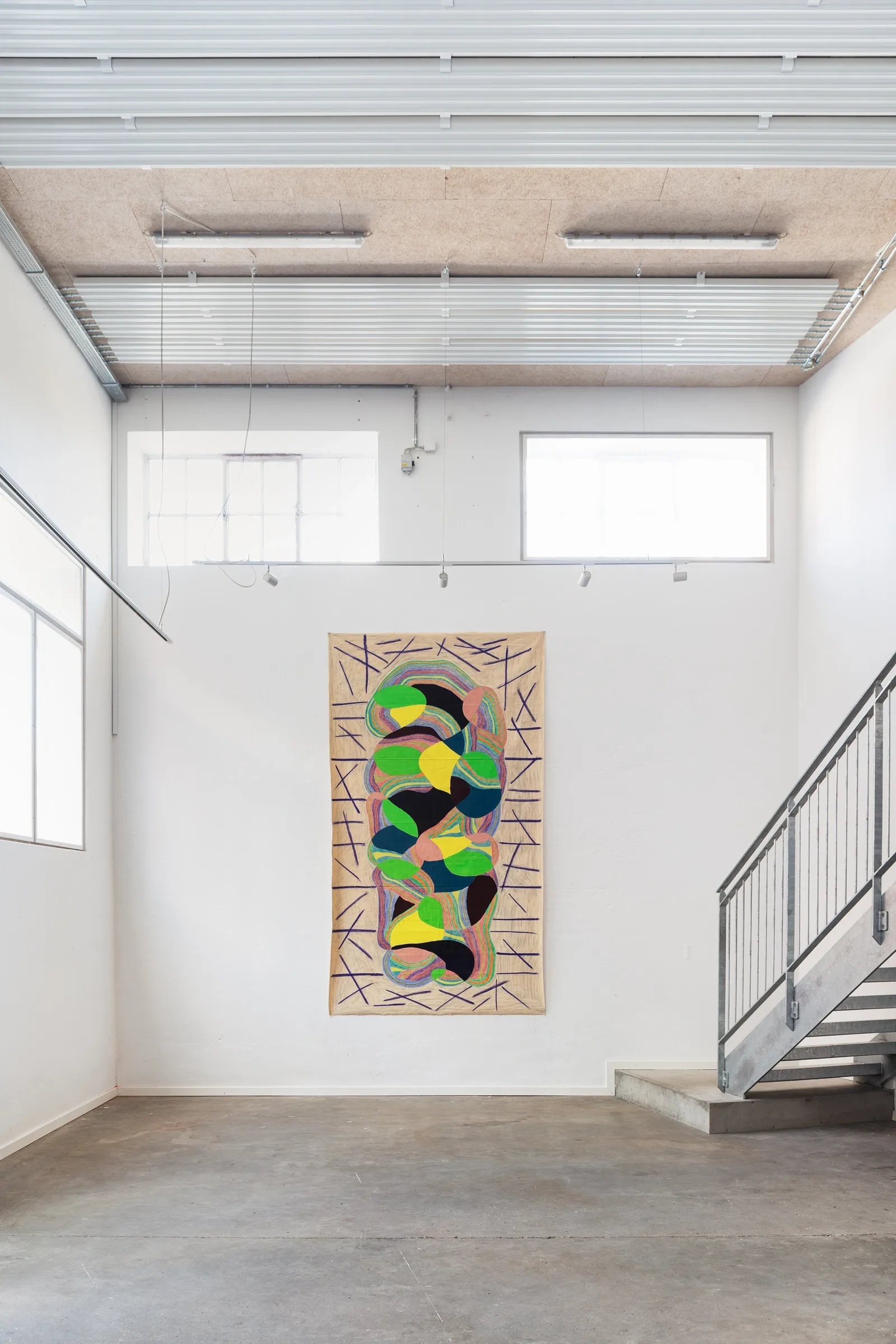 Artist Profile Feature: Sophie-Luise Passow, artwork at Aarhus Billedkunstcenter, 2026. Tall beige linen with green, yellow and black shapes, stairs beside.