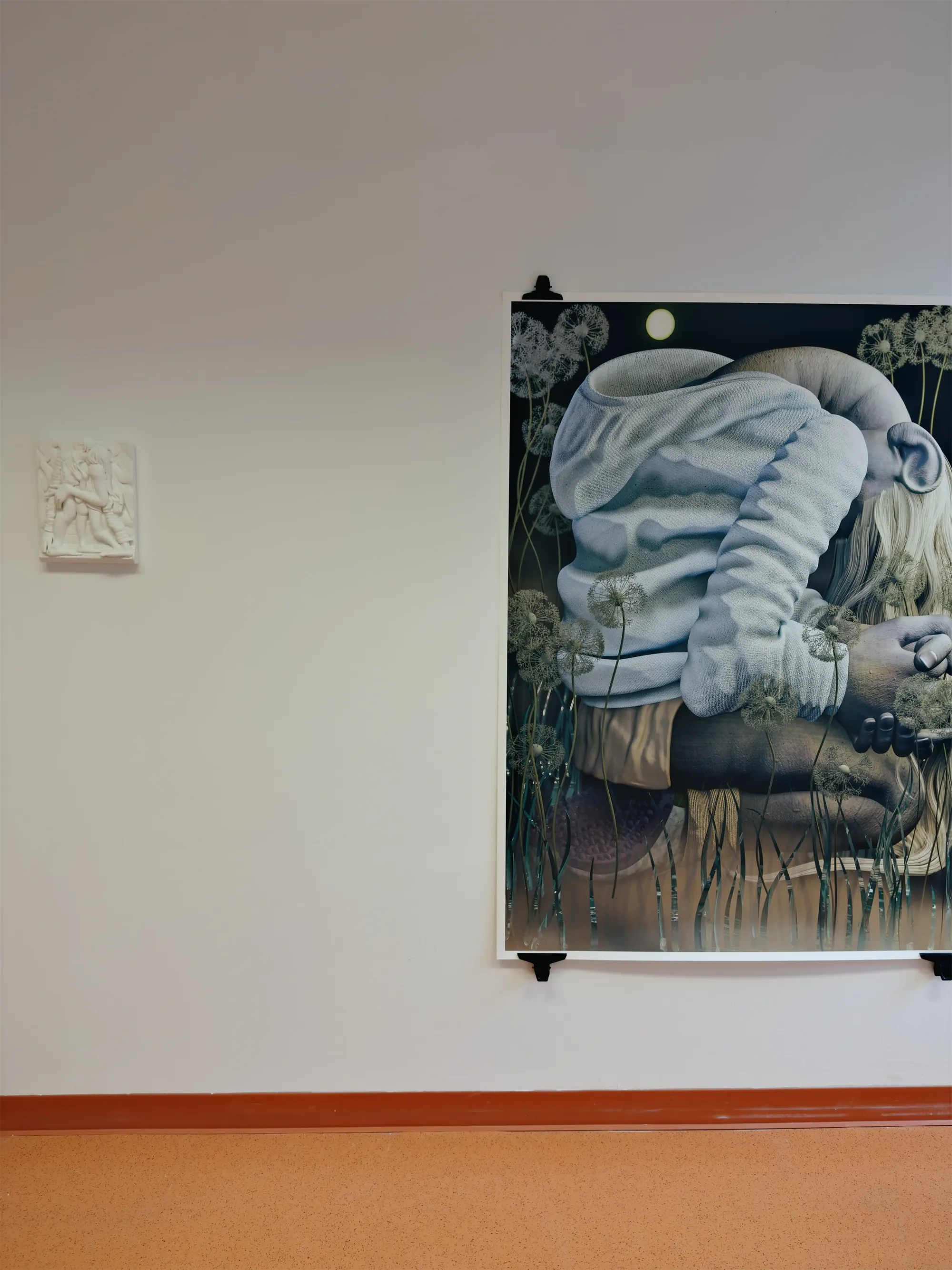 Artist Profile Feature: Yeji Seok, small white 3D-printed relief sculpture beside a large framed image of a hooded figure among dandelions on a gallery wall.