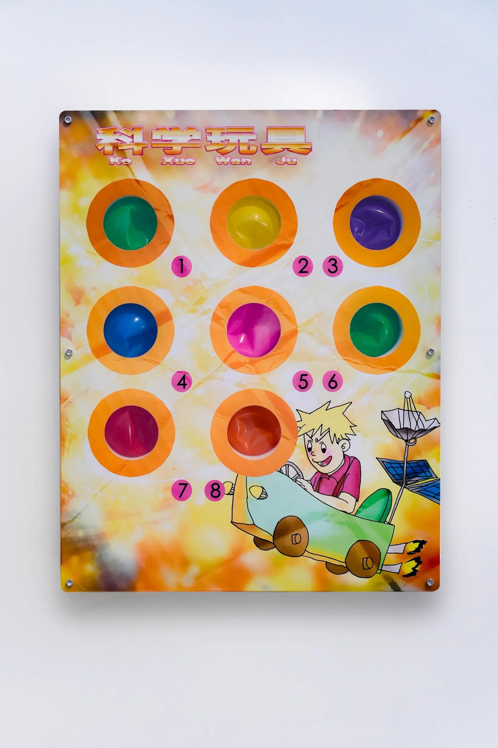 Exhibition review of Zhang Ting: TechDiumMory at TANK Shanghai, Shanghai, 2026. Yellow printed board with eight numbered colored ball hollows and a boy in a toy car.