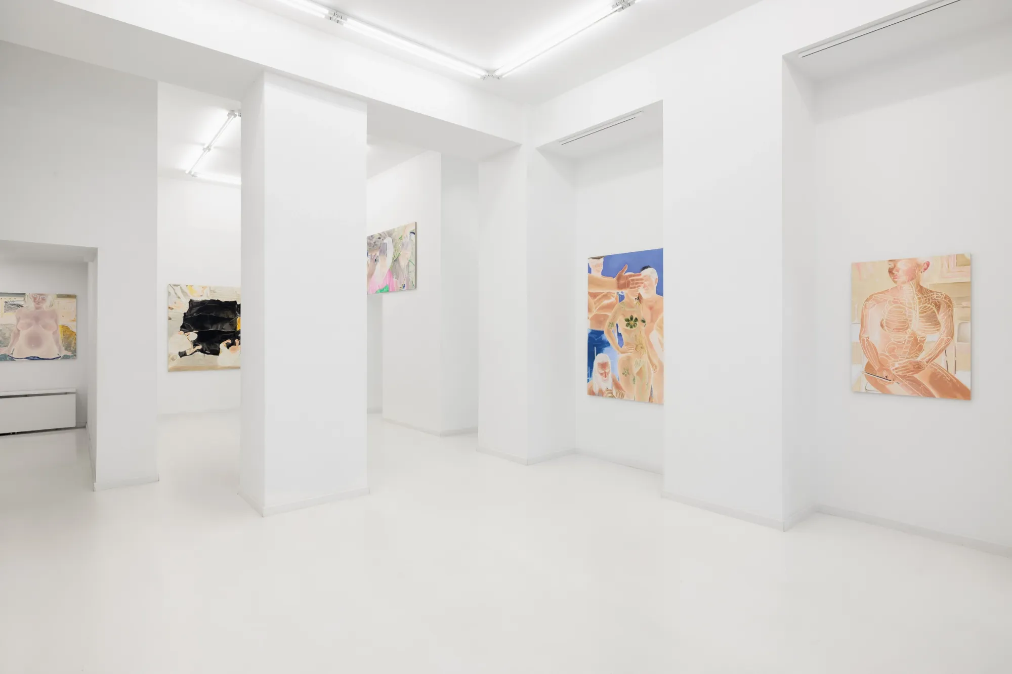 Exhibition review of Zofia Pałucha: Mother of One at HOS Gallery, Warsaw, 2026. Long white enfilade with pillars and paintings seen room after room.