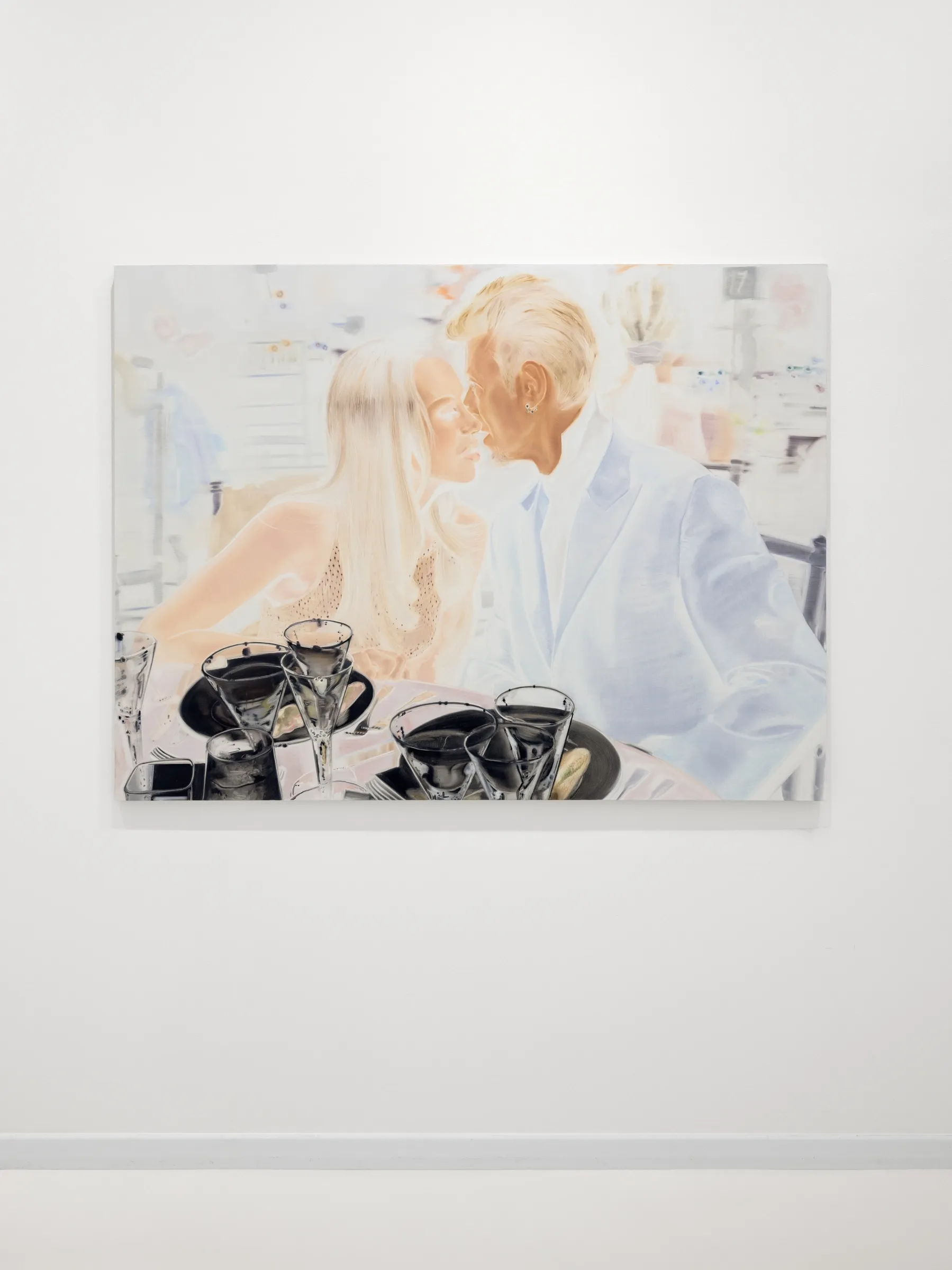 Exhibition review of Zofia Pałucha: Mother of One at HOS Gallery, Warsaw, 2026. Pale couple about to kiss at a restaurant table with dark glasses.