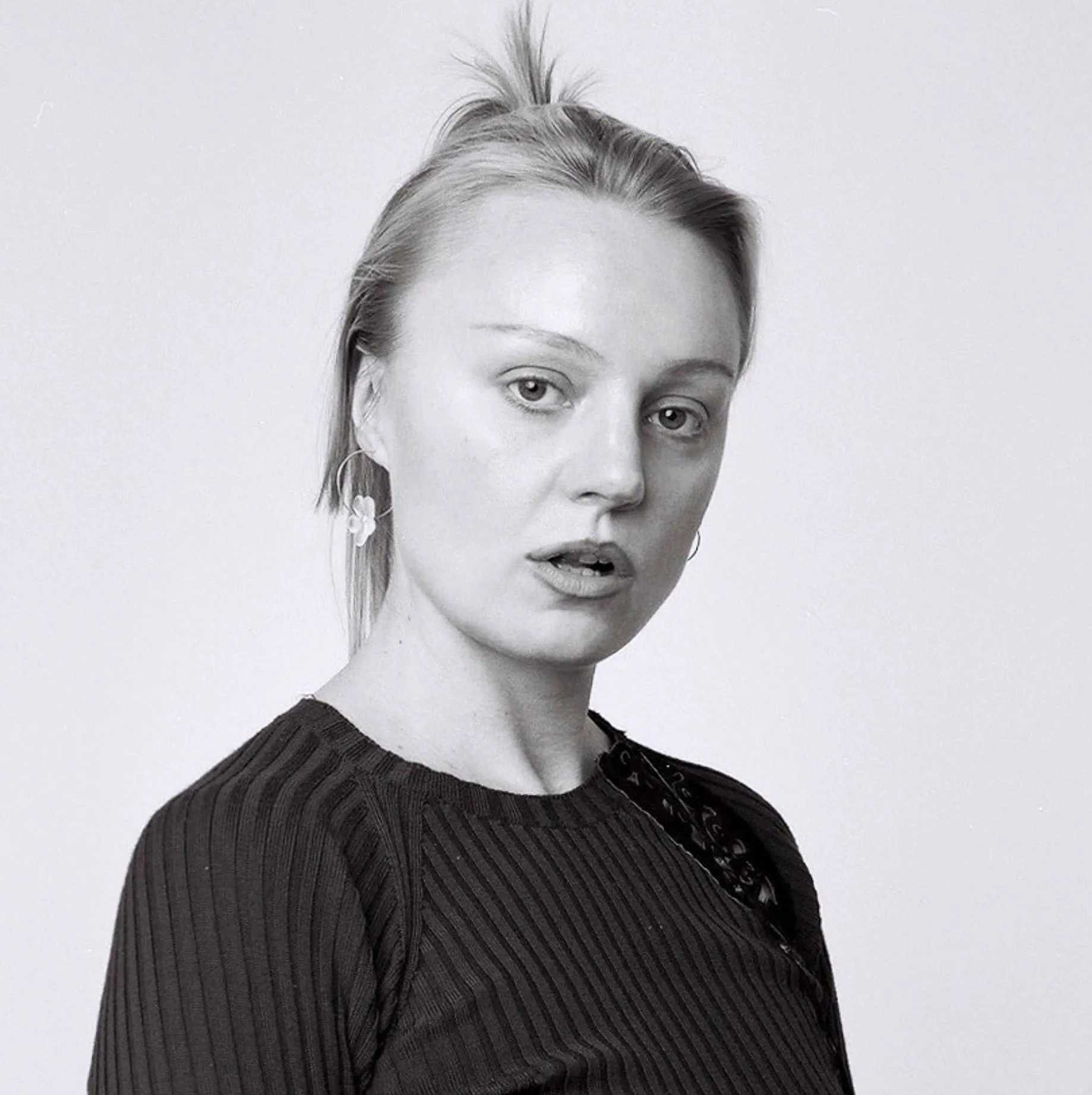 Anna Uddenberg, Telegraph Gallery, Olomouc: black and white portrait of the artist with hair tied up, wearing a dark ribbed top.