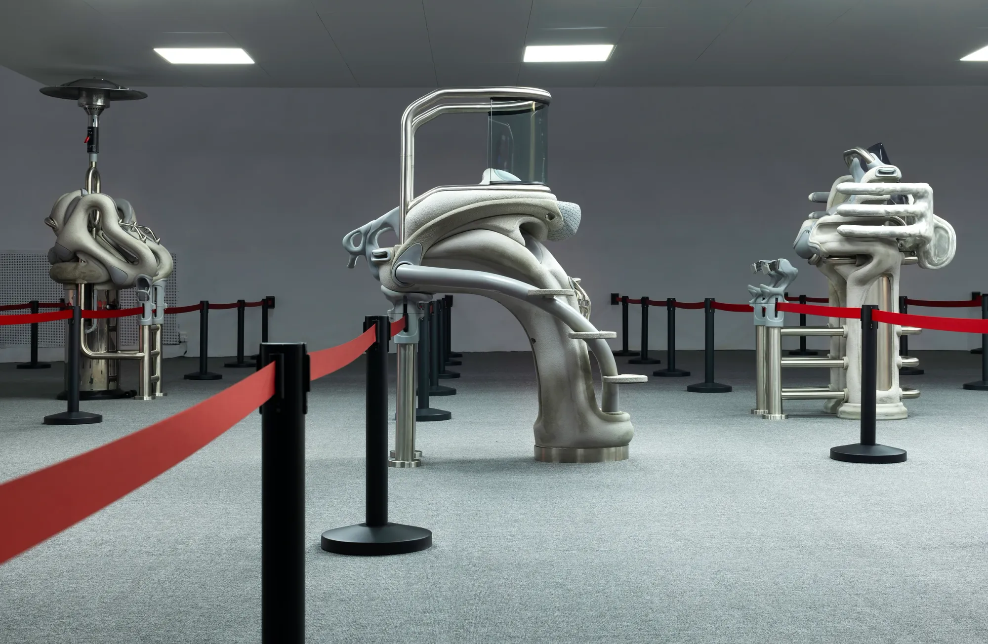 Anna Uddenberg, Telegraph Gallery, Olomouc: earlier installation with a glass-canopied grey sculpture behind red barrier ropes.