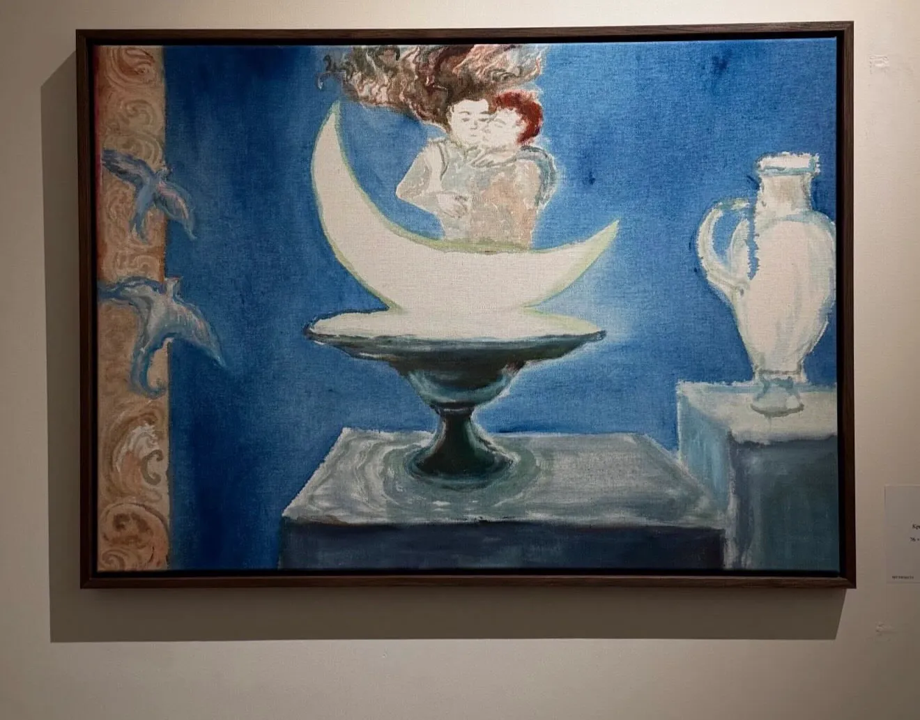Christina Arark: oil painting of two figures on a crescent moon above a footed bowl, blue ground, framed on a wall