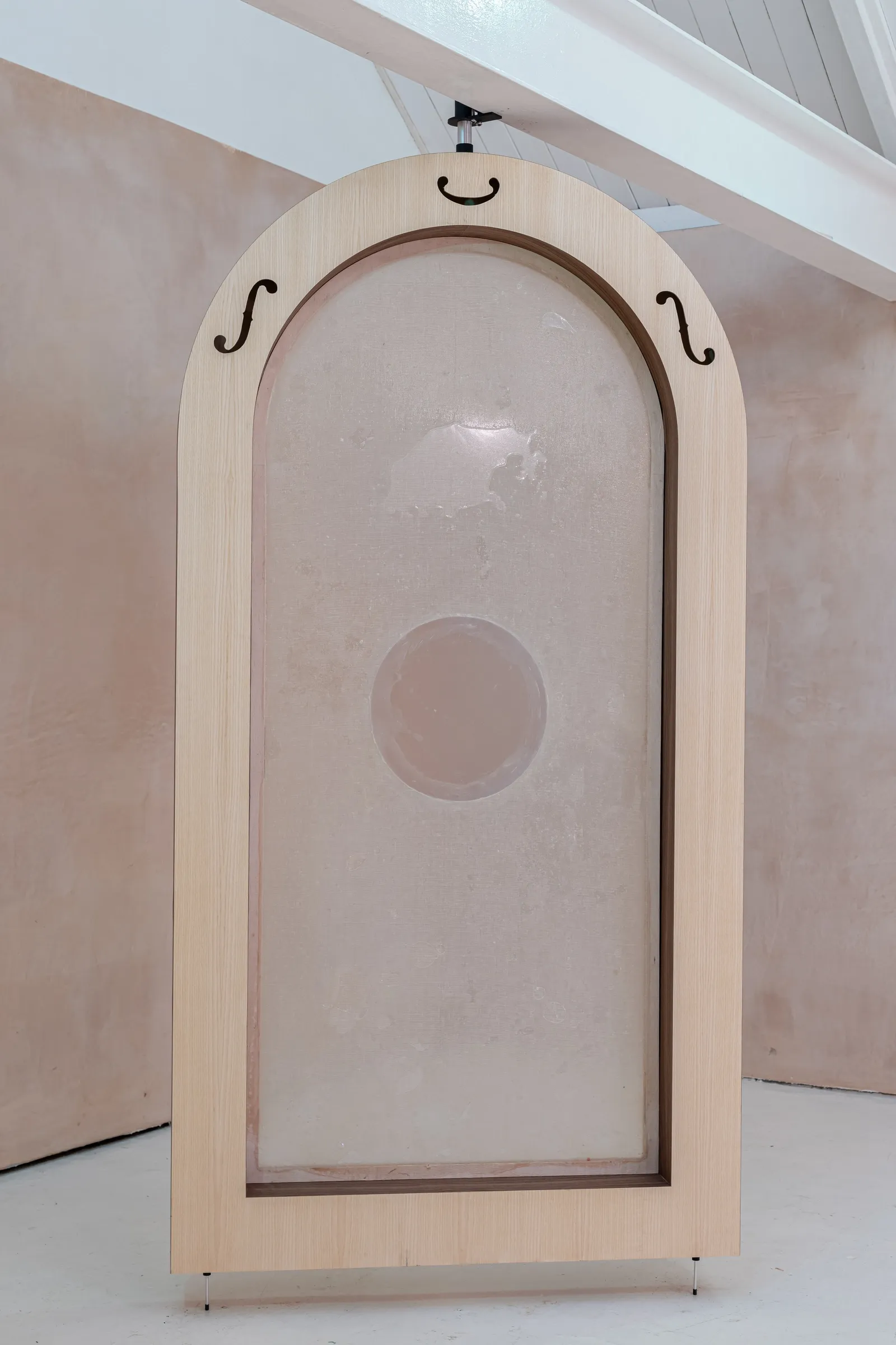 Tympanum by Finbar Prior at OUTPOST Gallery, Norwich, 2026, showing an arched wooden frame with a translucent membrane and decorative cut-outs.