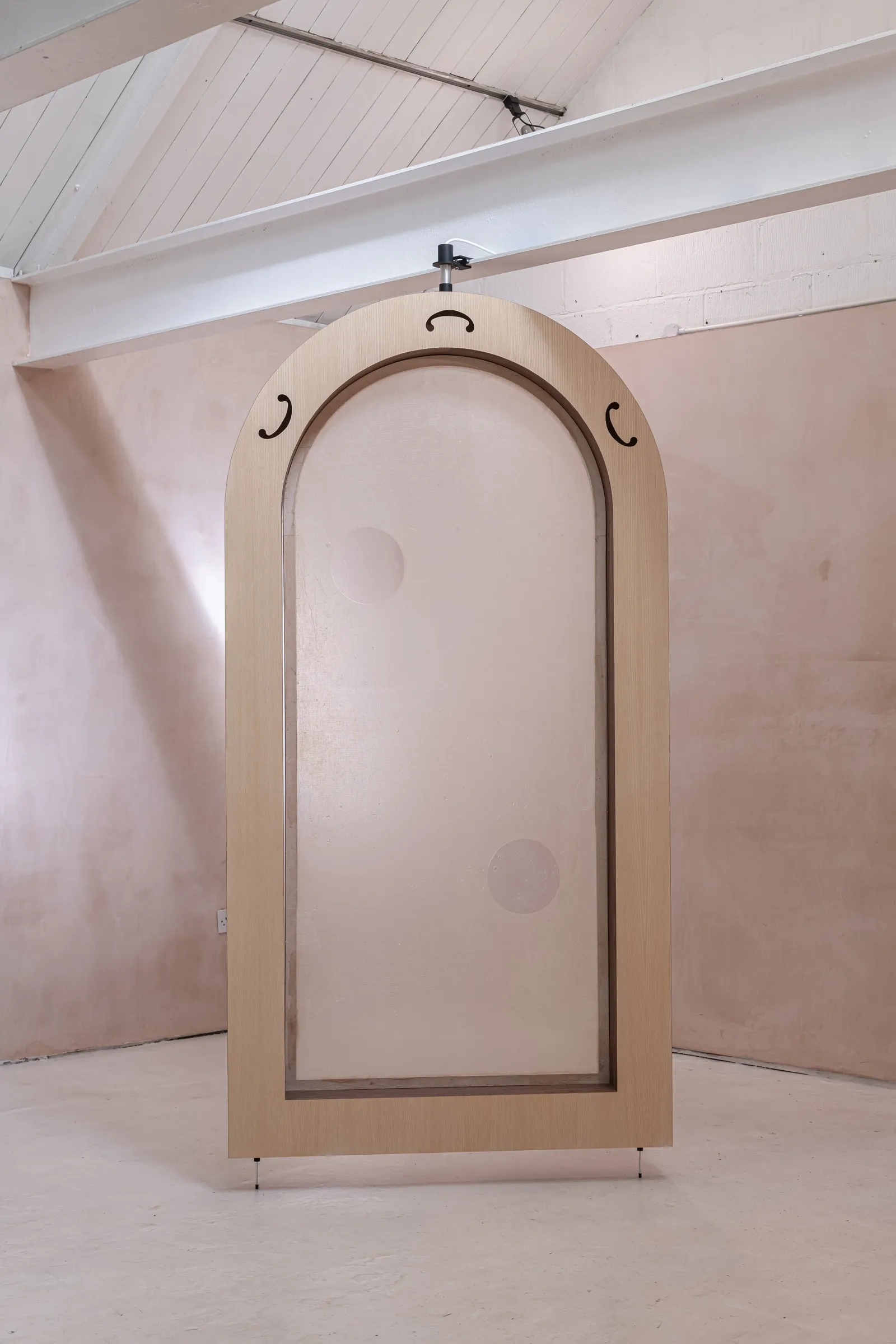 Tympanum by Finbar Prior at OUTPOST Gallery, Norwich, 2026, showing a pale wooden arch with translucent membrane and circular patches.