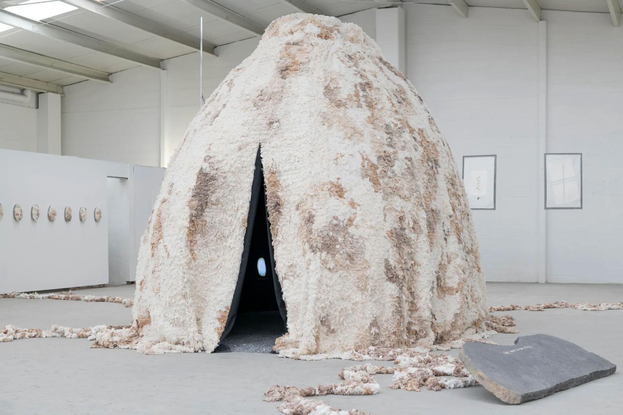 Artist Profile Feature: KiefferWoodtli, AXES, Alvarez Chida, Mexico City, 2026. Domed fibre installation with a narrow dark entrance and a stone slab.