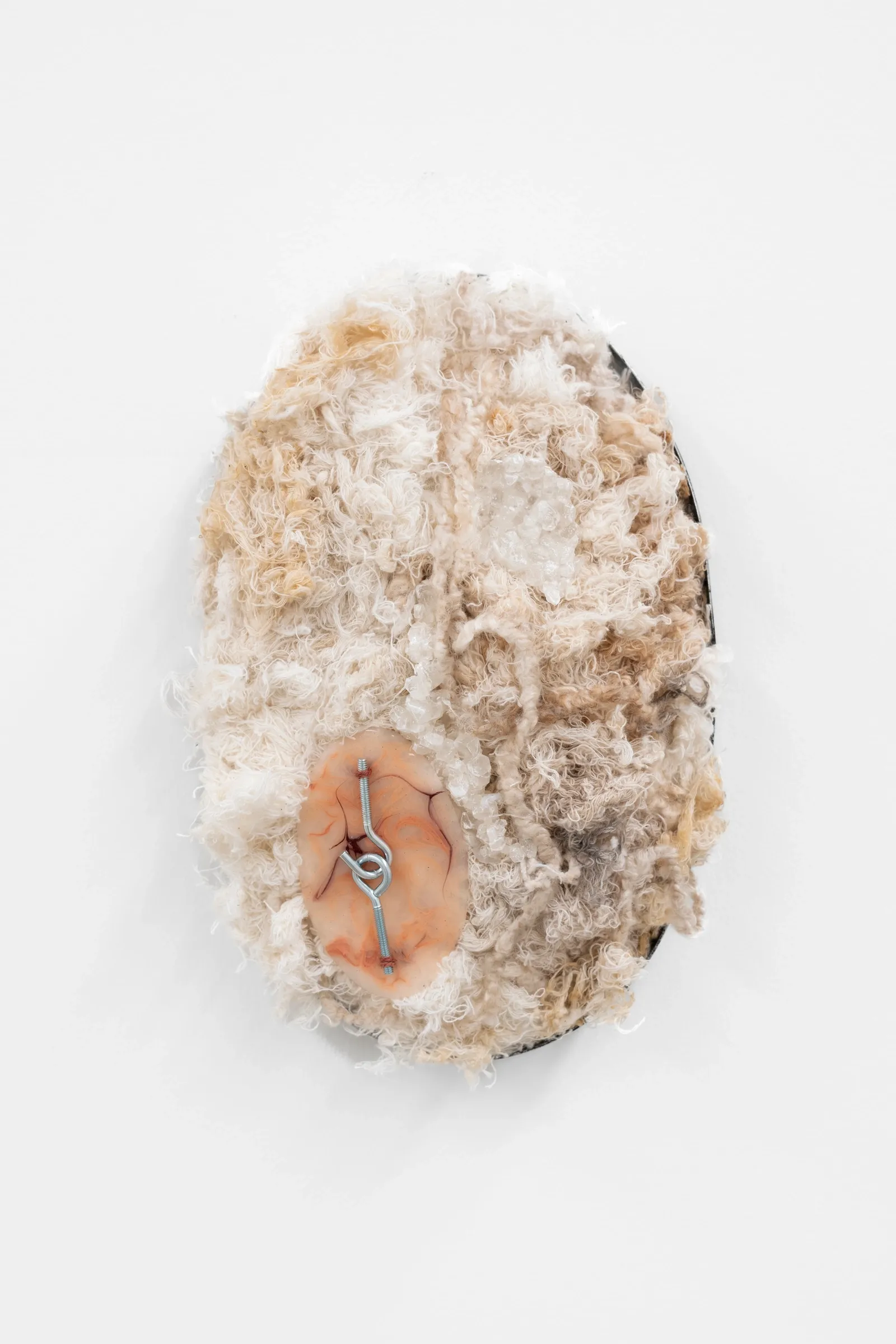 Artist Profile Feature: KiefferWoodtli, AXES, Alvarez Chida, Mexico City, 2026. Oval wall piece of cream and tan fibre with a small metal hook.