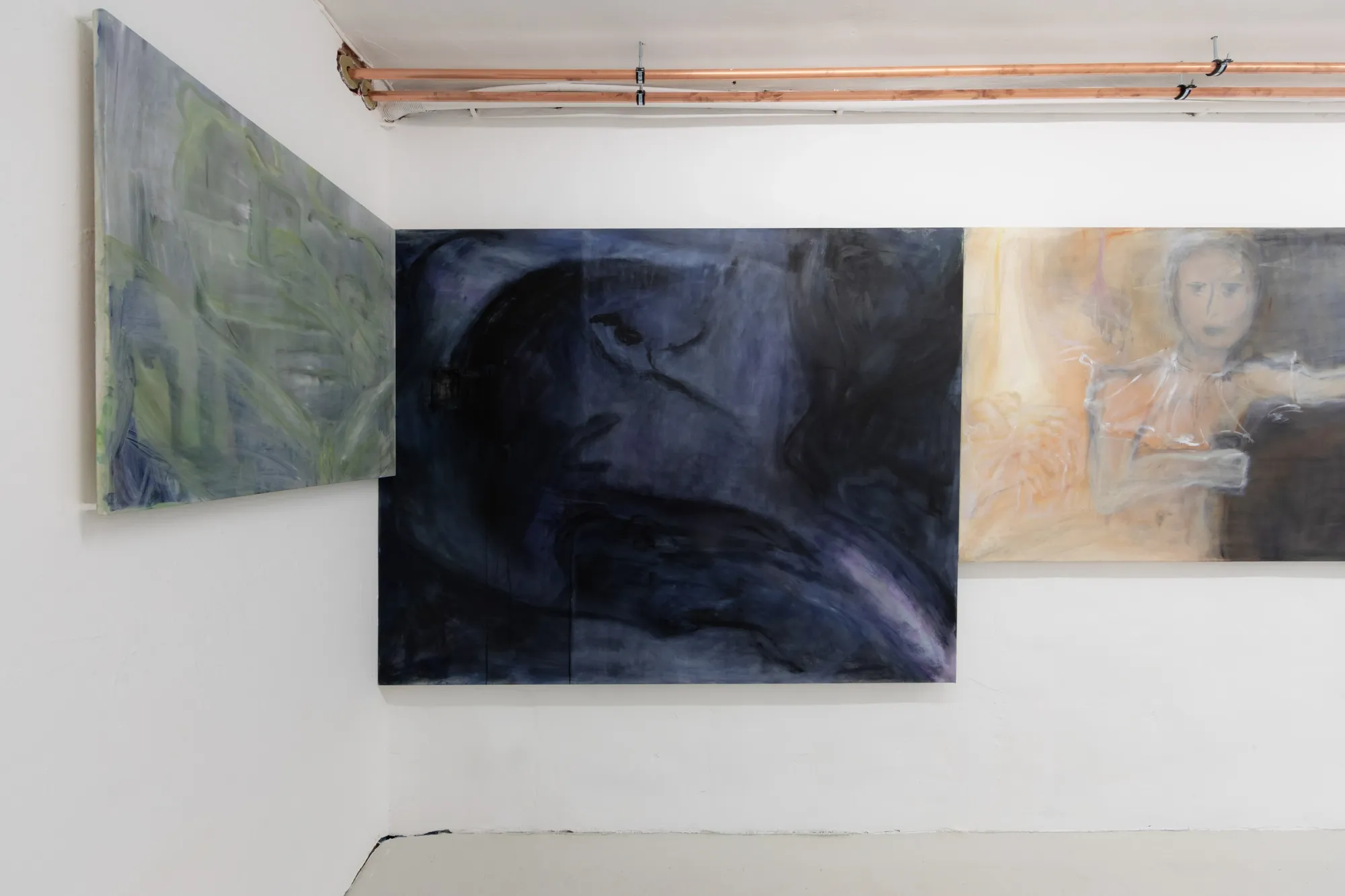 Exhibition review of Krys Huba: falling into you at soft power, Berlin, 2026. Green painting on the corner wall beside a dark blue-black canvas.