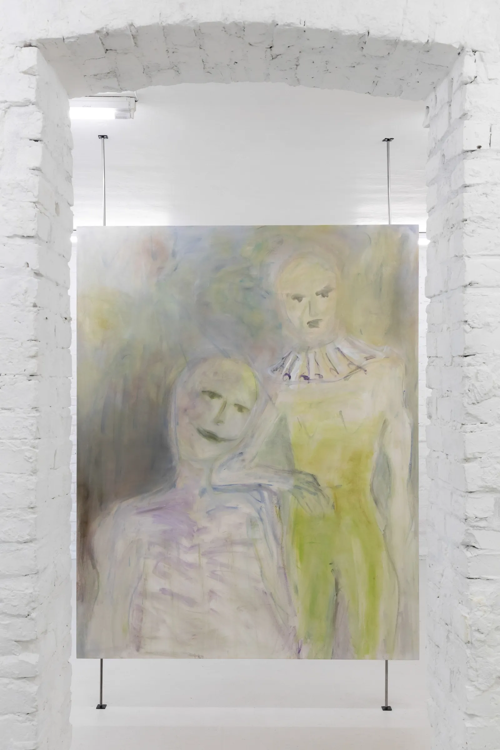 Exhibition review of Krys Huba: falling into you at soft power, Berlin, 2026. Two pale figures, one in a ruff collar, hung in a brick archway.