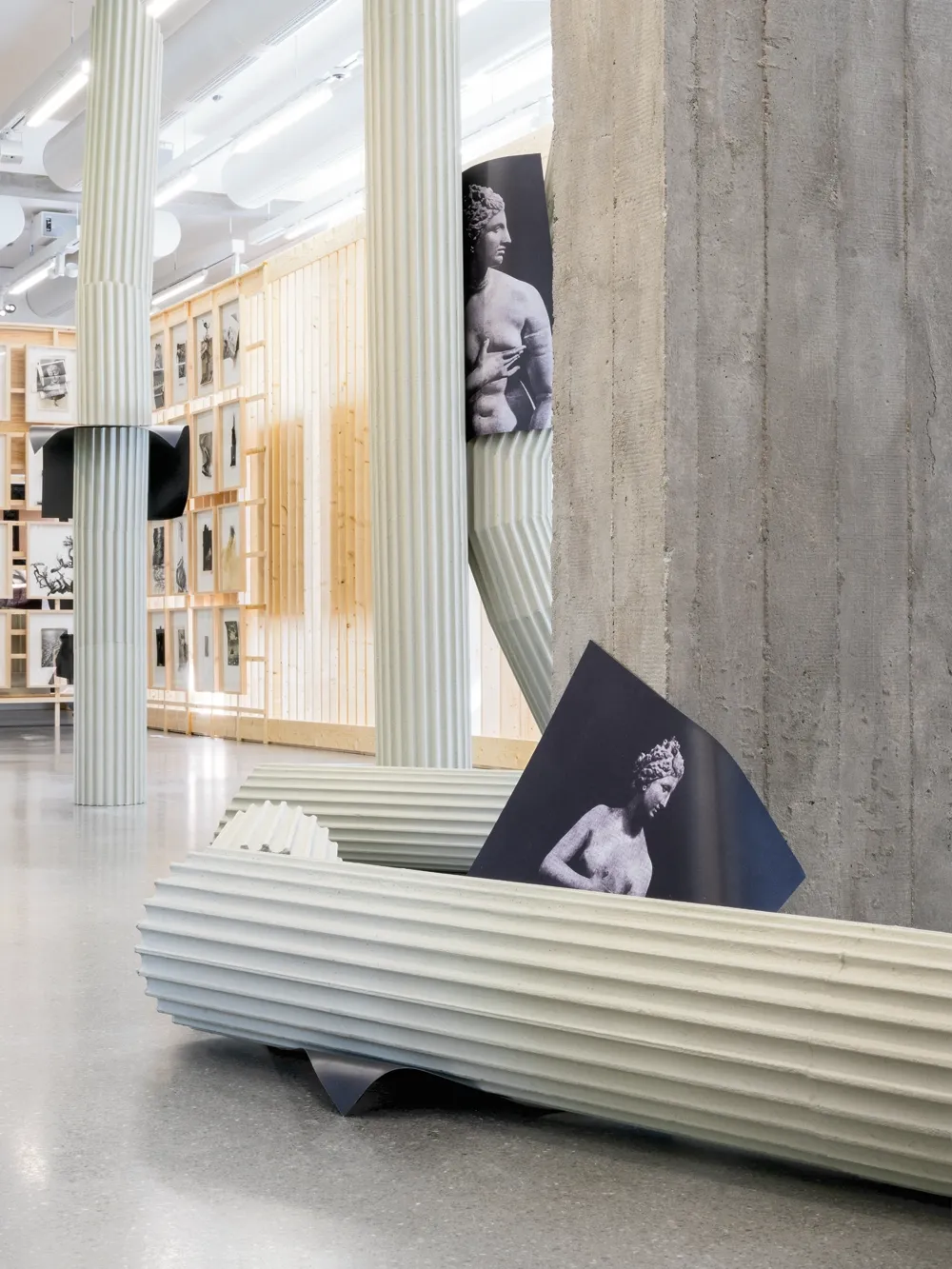 Lucia Tallová, PalaisPopulaire, Berlin: pale green fluted column lying on the floor beside a printed image of a female torso.