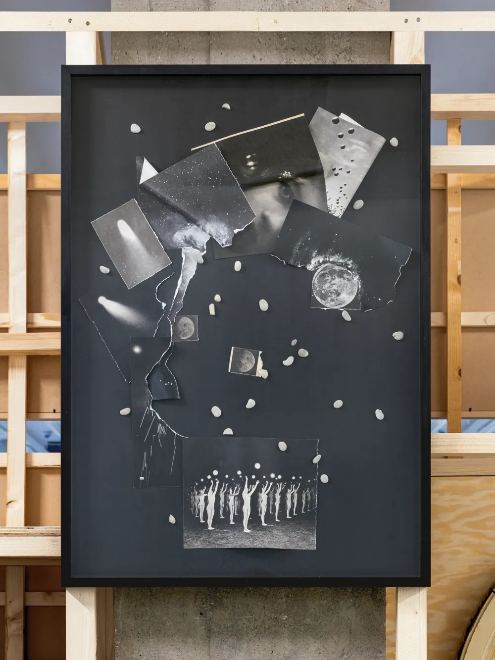 Lucia Tallová, PalaisPopulaire, Berlin: black-framed collage of cut comet and moon photographs with small white stones on top.