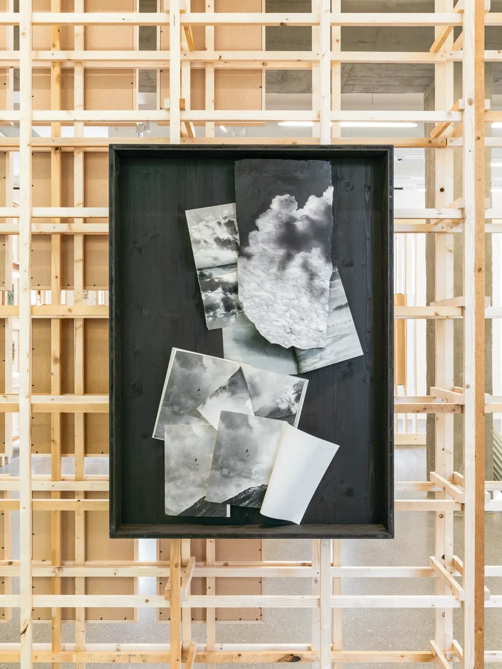 Lucia Tallová, PalaisPopulaire, Berlin: black frame with layered cloud and sky photographs cut and overlapped on a black panel.