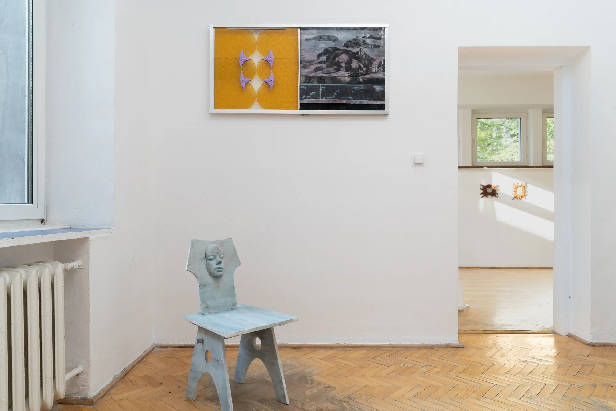 Gutkowska, Szablak, Wierzbicka, Woroszył, MISE EN, Warsaw: pale blue plywood chair with a cast face below a yellow and black framed panel.