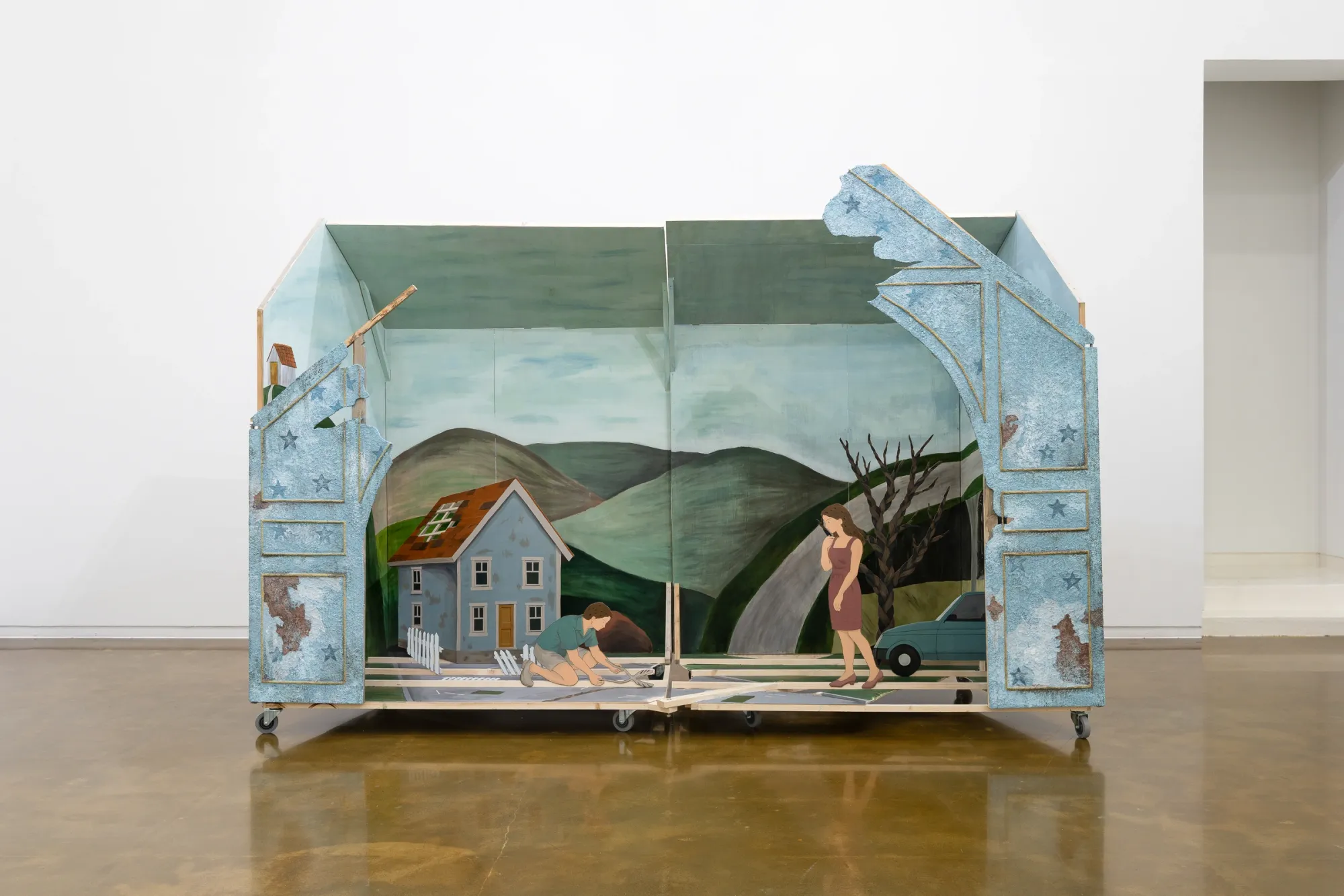  ALT: Seongeun Lee, Cheongju Art Studio, Cheongju: a pale blue house structure on casters, open to hills, a blue house and a standing woman.