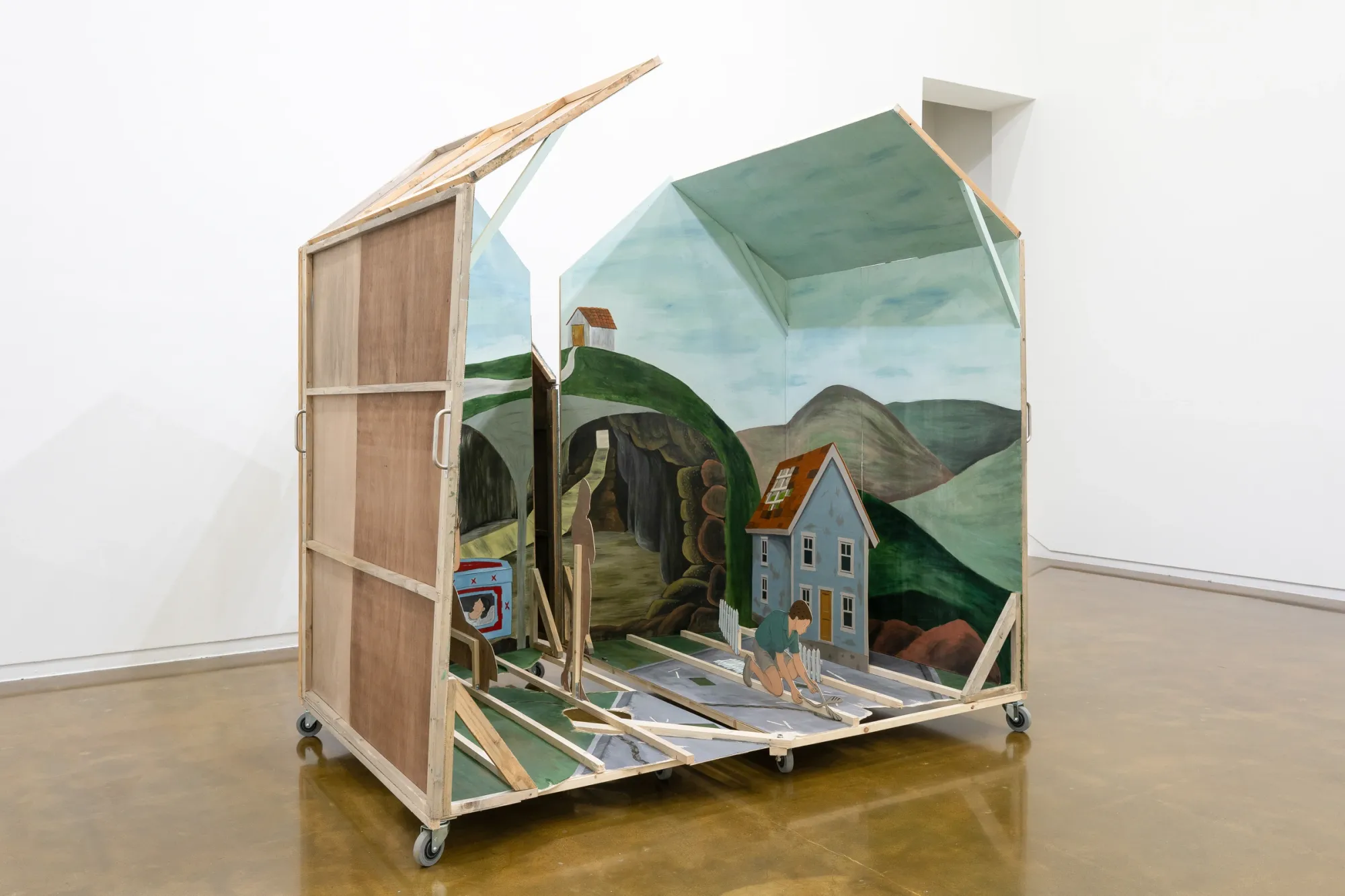 Seongeun Lee, Cheongju Art Studio, Cheongju: a house on casters split into two halves, plywood back at left, blue house in the right half.