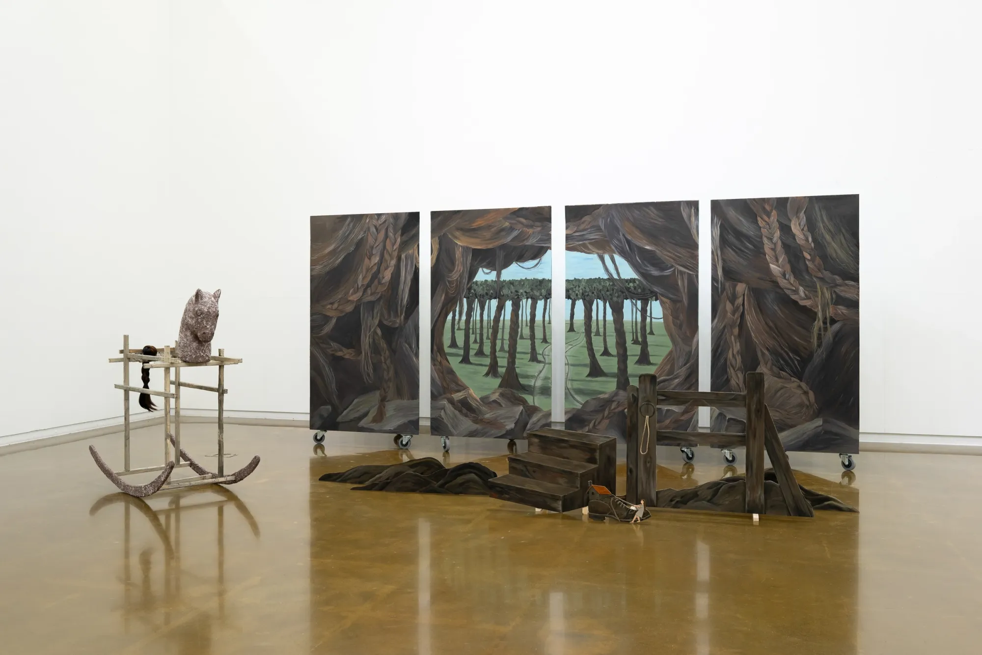 Seongeun Lee, Cheongju Art Studio, Cheongju: four painted columns on casters with dark braided cave forms framing a tree-lined field.