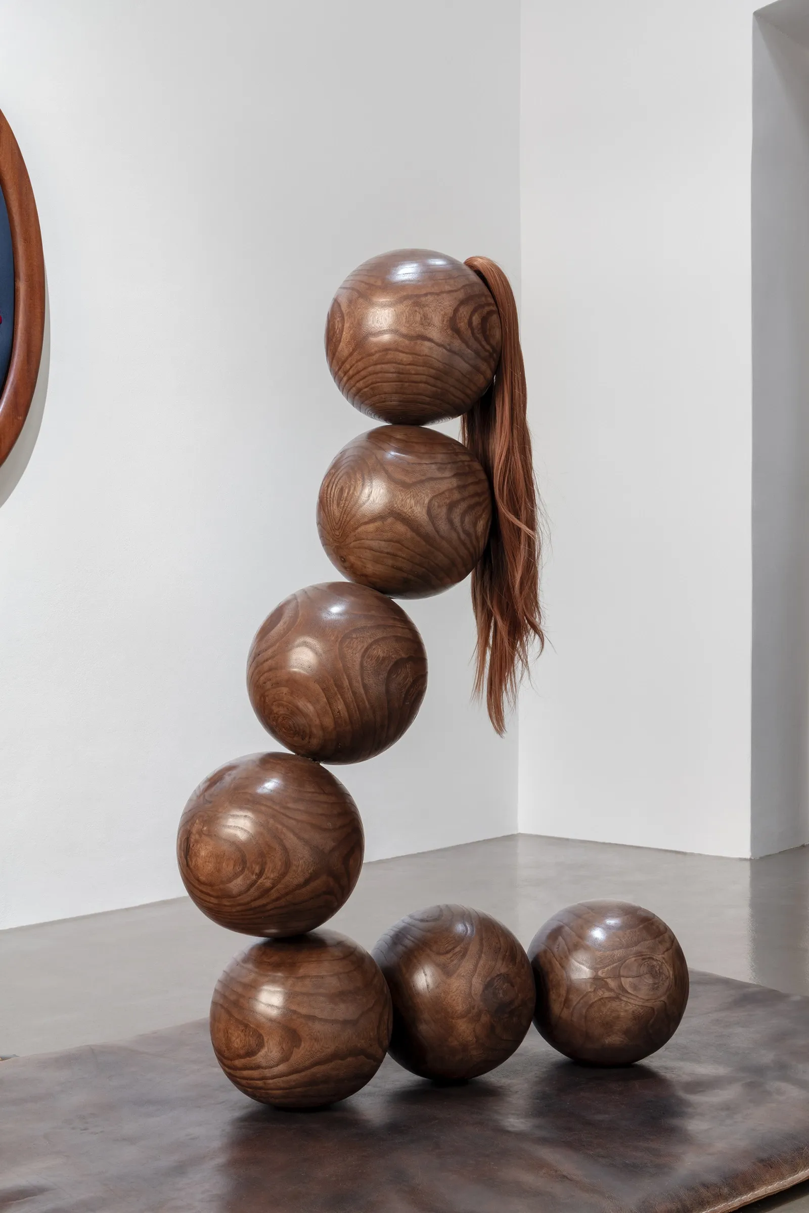Tereza Kalousová, Clauda, Prague: stacked polished wooden spheres with synthetic hair hanging from the top sphere