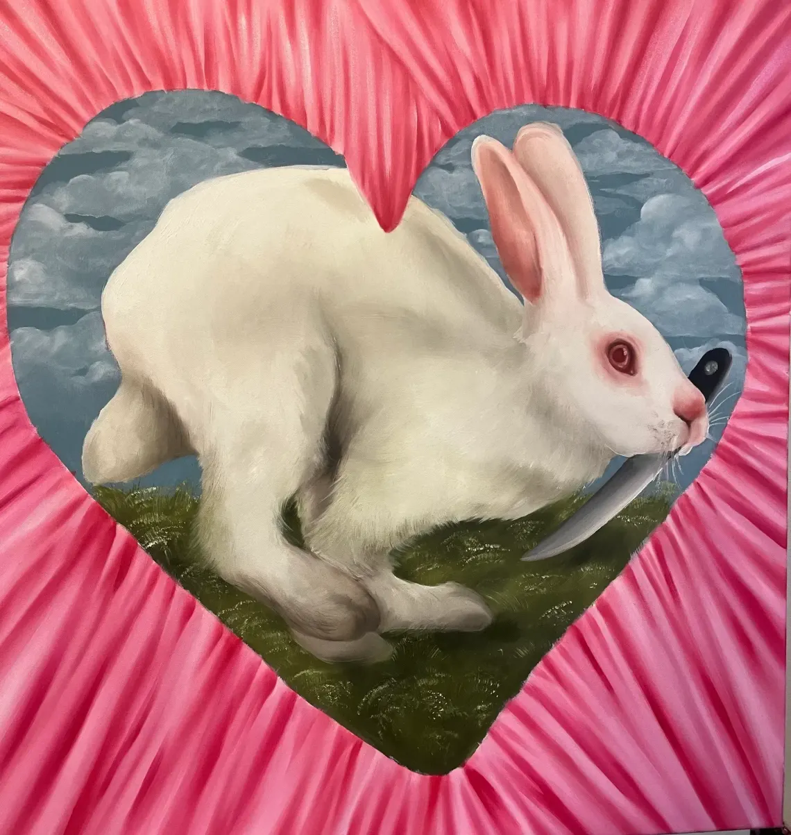 Dominika Kováčiková, 2024 oil painting of a white rabbit holding a knife in its mouth, framed by a pink heart against stormy skies.