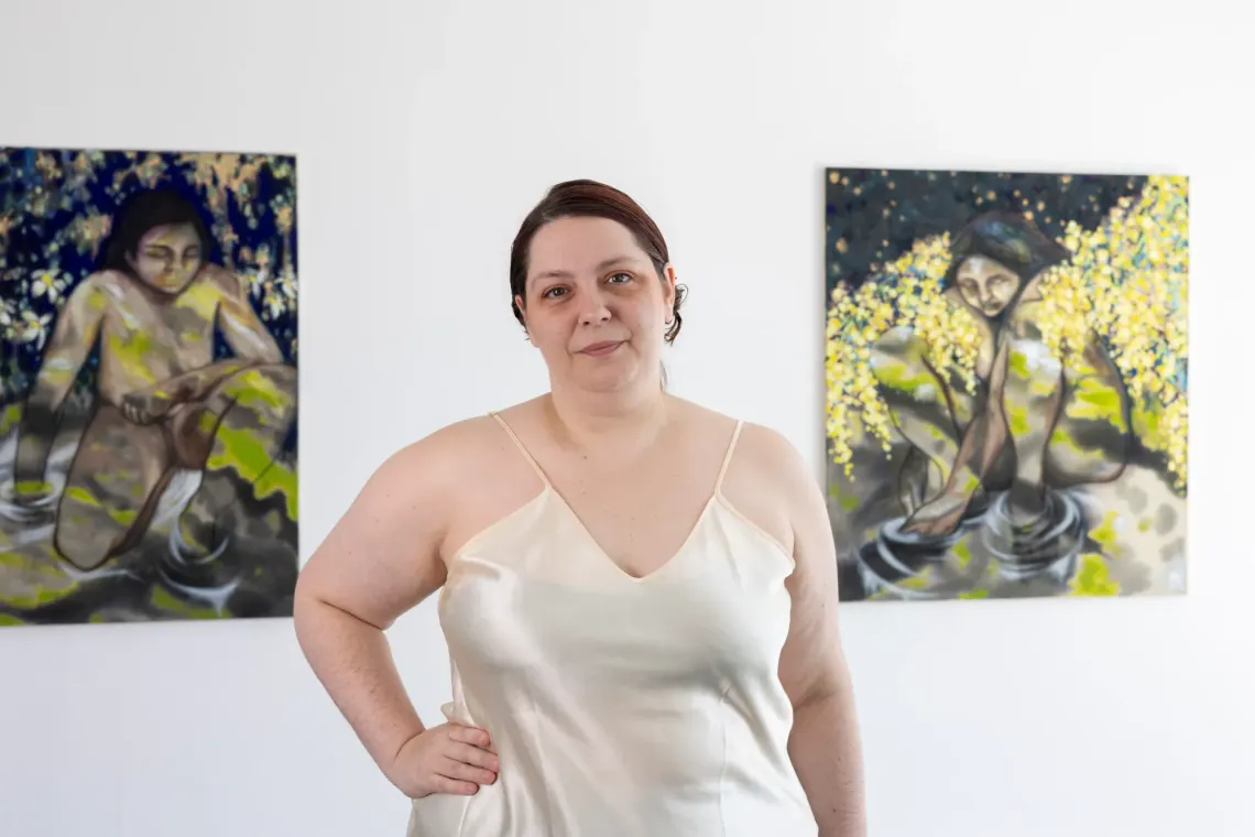 catapult contemporary feature. Exhibition review of Candy Bassas: dancing lights at Galerie Mellies, Detmold, 2026. The artist in a cream slip dress between two paintings of bathers.