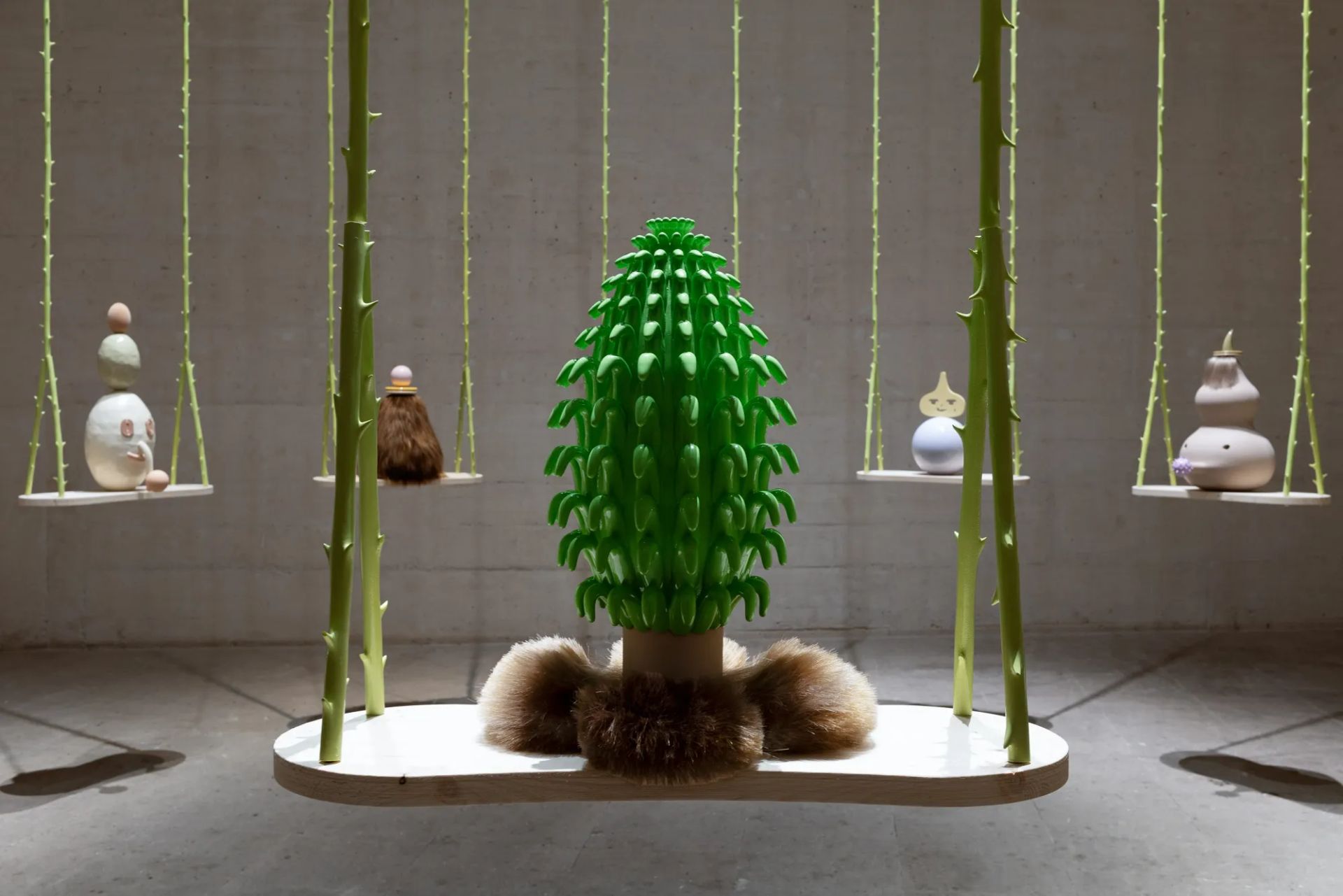 Grip Face, Utopía del Lodo y Sashimi de Bruma, installation view with green cactus-like sculpture and suspended swing platforms, Miró Foundation Museum, Barcelona contemporary art exhibition.