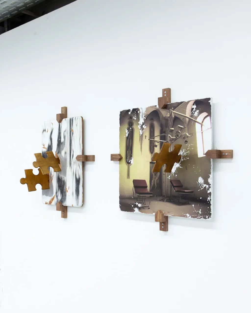 Vivienne Sun Liminality installation detail showing photographic works mounted on wooden puzzle-like brackets referencing institutional interiors