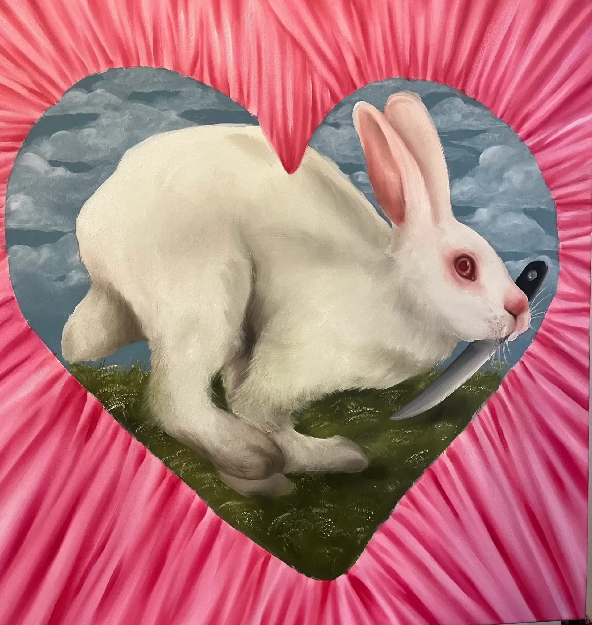 Dominika Kováčiková, 2024 oil painting of a white rabbit holding a knife in its mouth, framed by a pink heart against stormy skies.