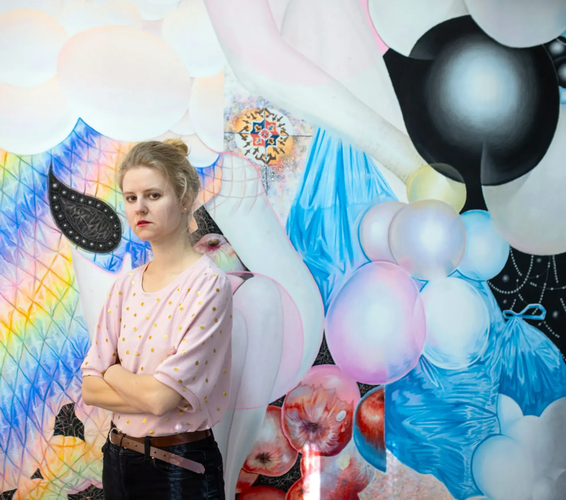 Karolína Netolická, Prague: the artist stands in front of her large pastel painting Breeders.
